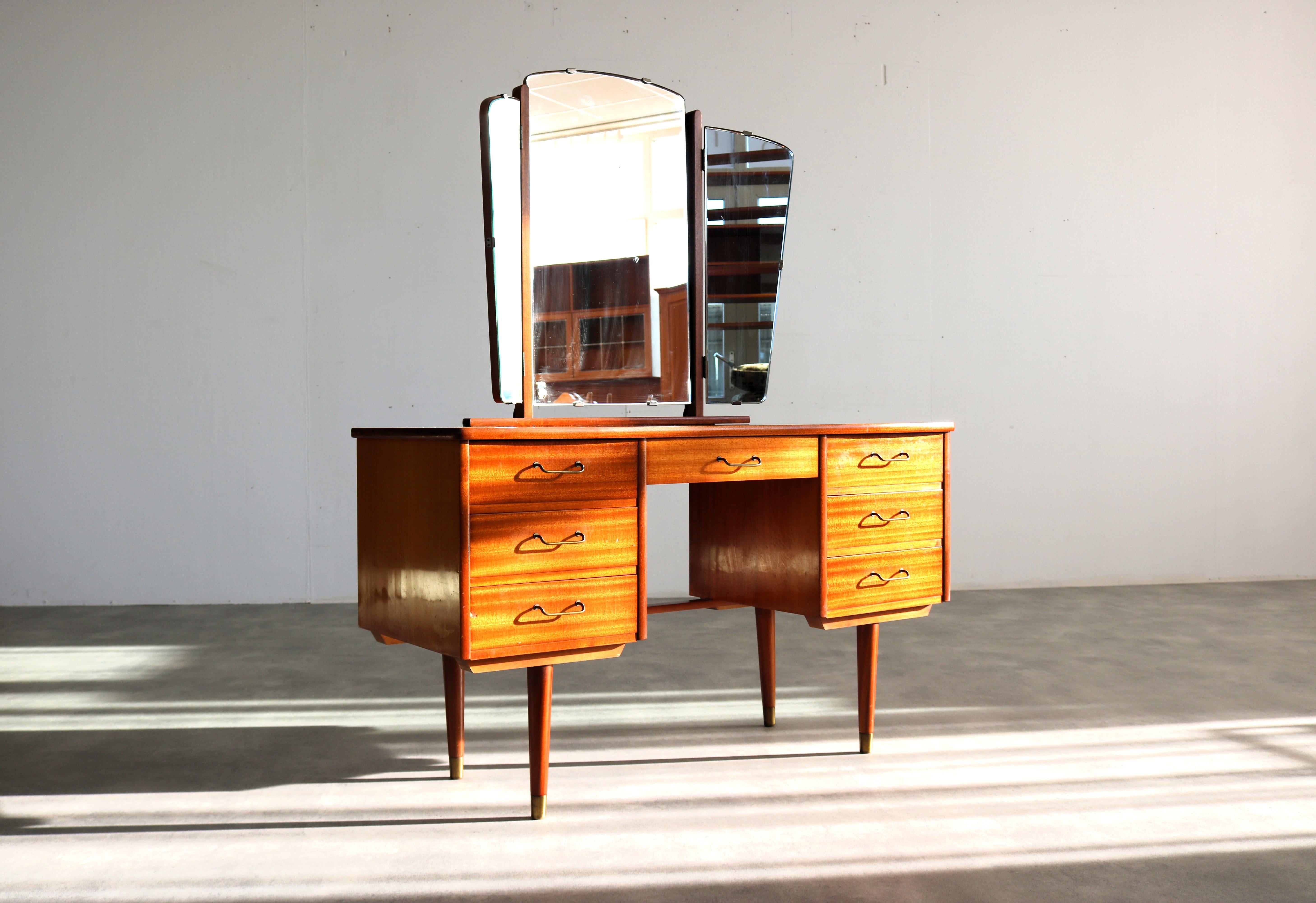 vintage dressing table | 60s | Sweden

period | 60's
design | unknown | Sweden
condition | good | light signs of use | burn mark
size | 138 x 115 x 44 (hxwxd) table height: 69 cm;

details | teak; brass; glass;

article number | 2232