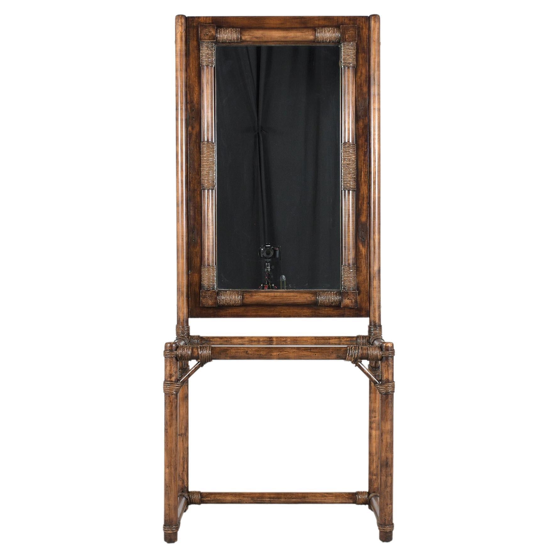 An extraordinary faux bamboo vanity table is in great condition and has been fully restored by our team of craftsmen. This lovely piece features a bamboo design stained in a walnut color with a beautiful patina finish framed rectangular mirror fully
