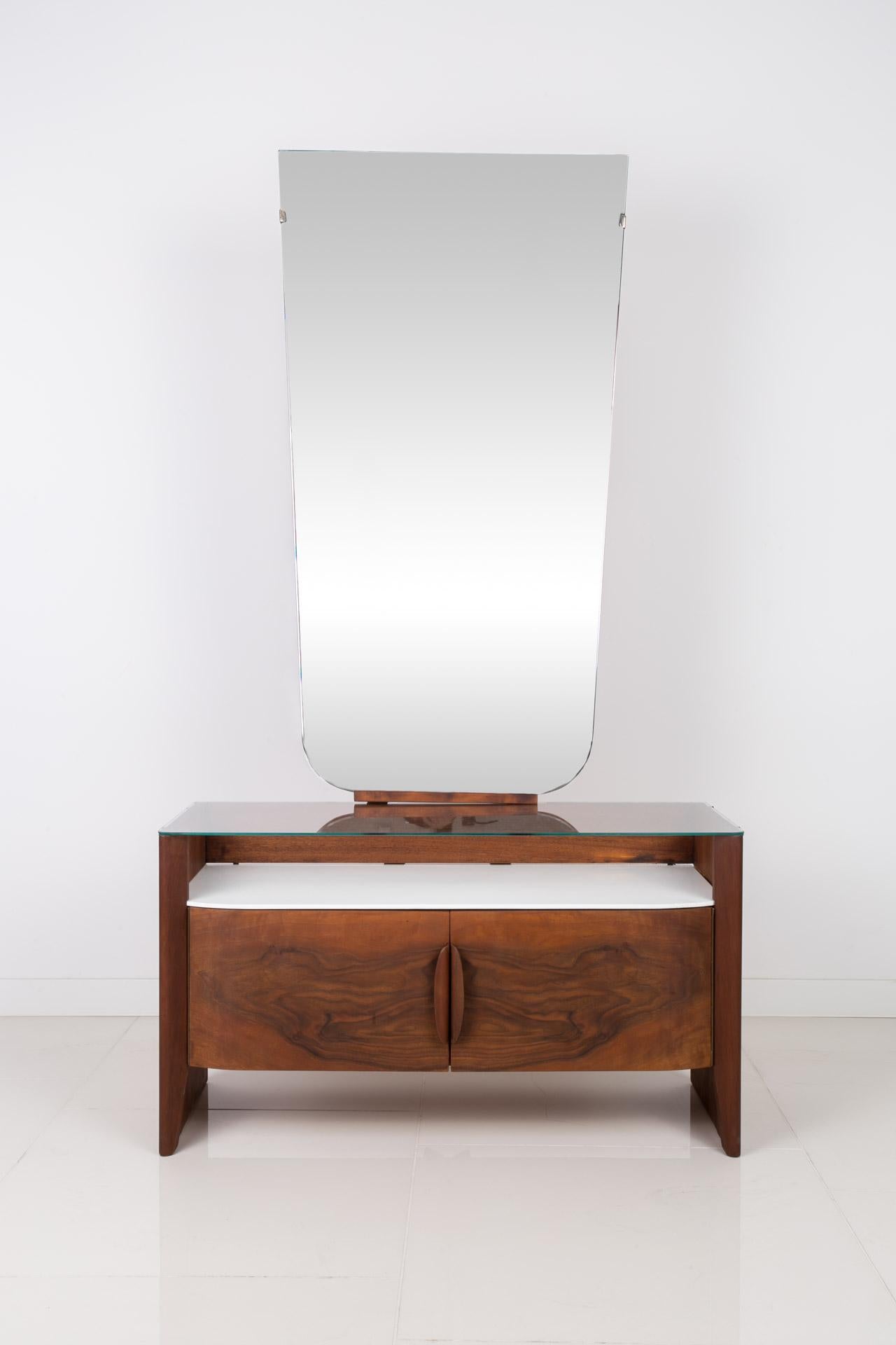 This dressing table was designed by famous Czech designer Jindrich Halabala and manufactured around 1950s. The piece is in very good original condition. It features a big vertical mirror and a practical storage space below it. Wooden elements are