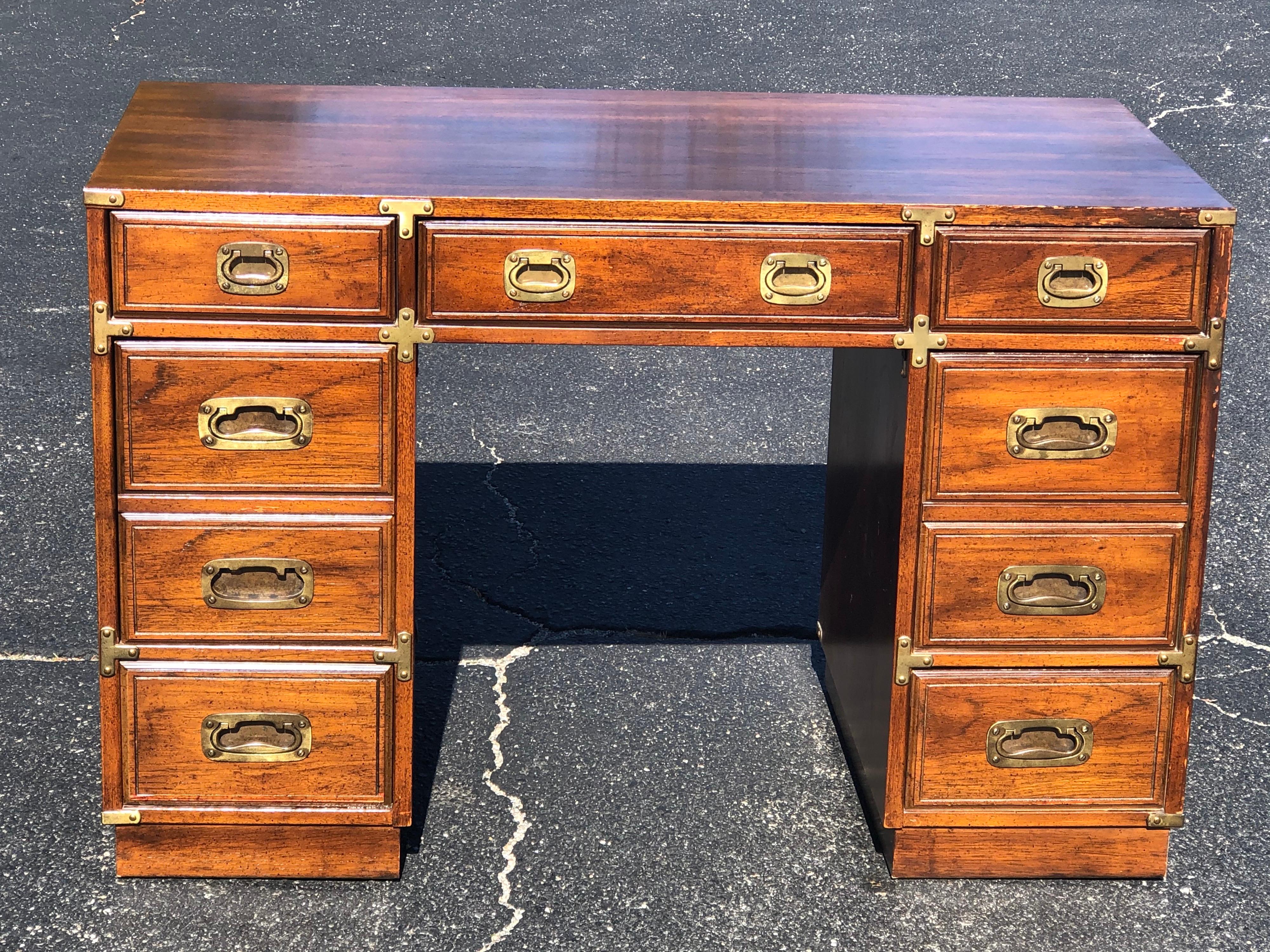 Vintage Drexel Campaign desk. Classic design and great storage. This would also look great painted in a bright color. Some discoloration on top from where a desk blotter blocked the sun. One handle pull is a bit lighter in brass tone as we have