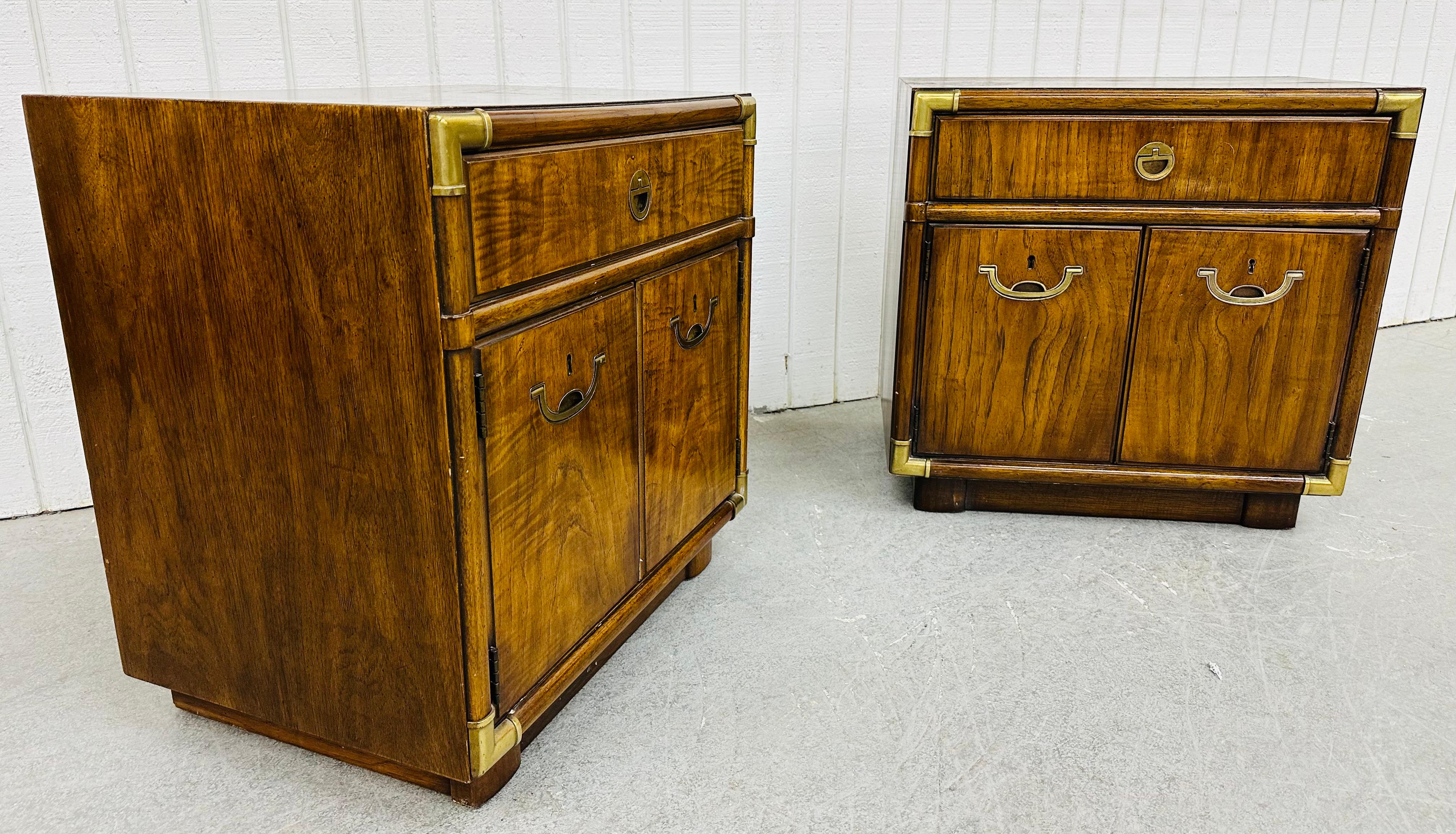This listing is for a pair of Vintage Drexel Campaign Style Walnut Nightstands. Featuring a straight line design, original campaign style brass hardware, single drawer at the top, two doors that open to storage space, and a beautiful walnut finish.
