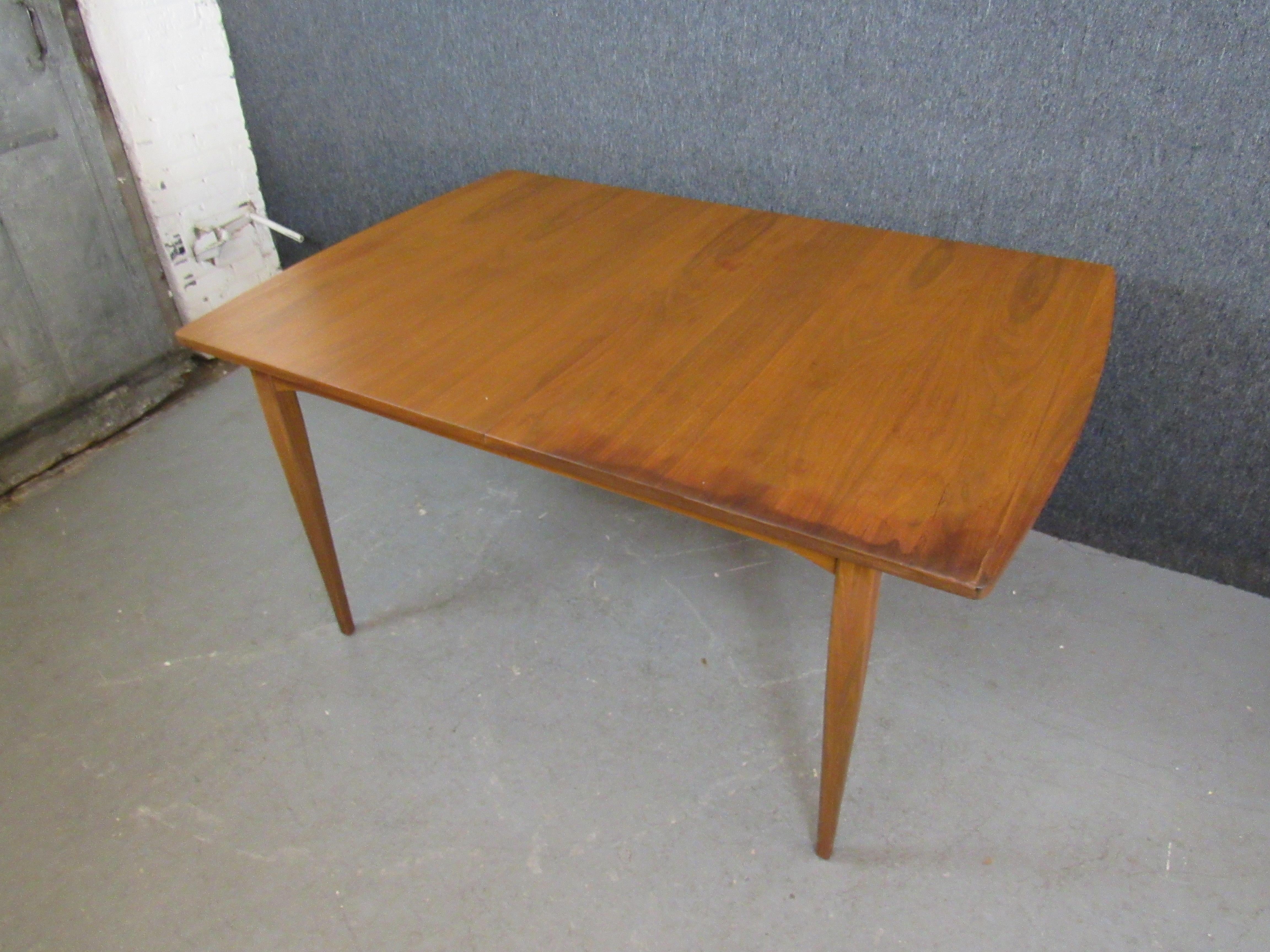 Bring home renowned vintage design with this walnut dining table from Kipp Stewart's iconic 