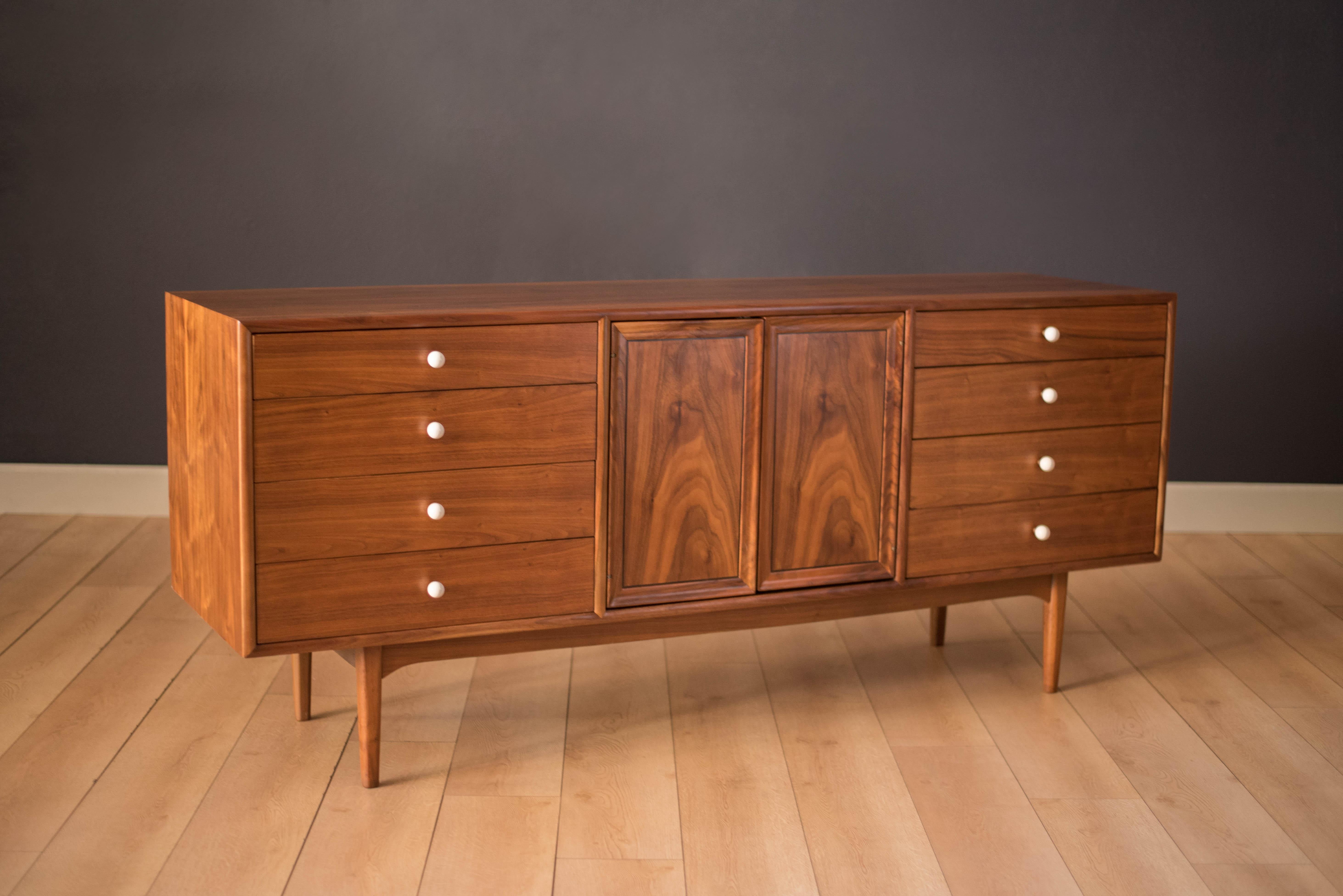 Mid century Drexel declaration dresser designed by Kipp Stewart and Stewart MacDougall. This piece features bookmatched black walnut grains highlighted by the collection's signature white porcelain and brass pulls. Offers plenty of storage including