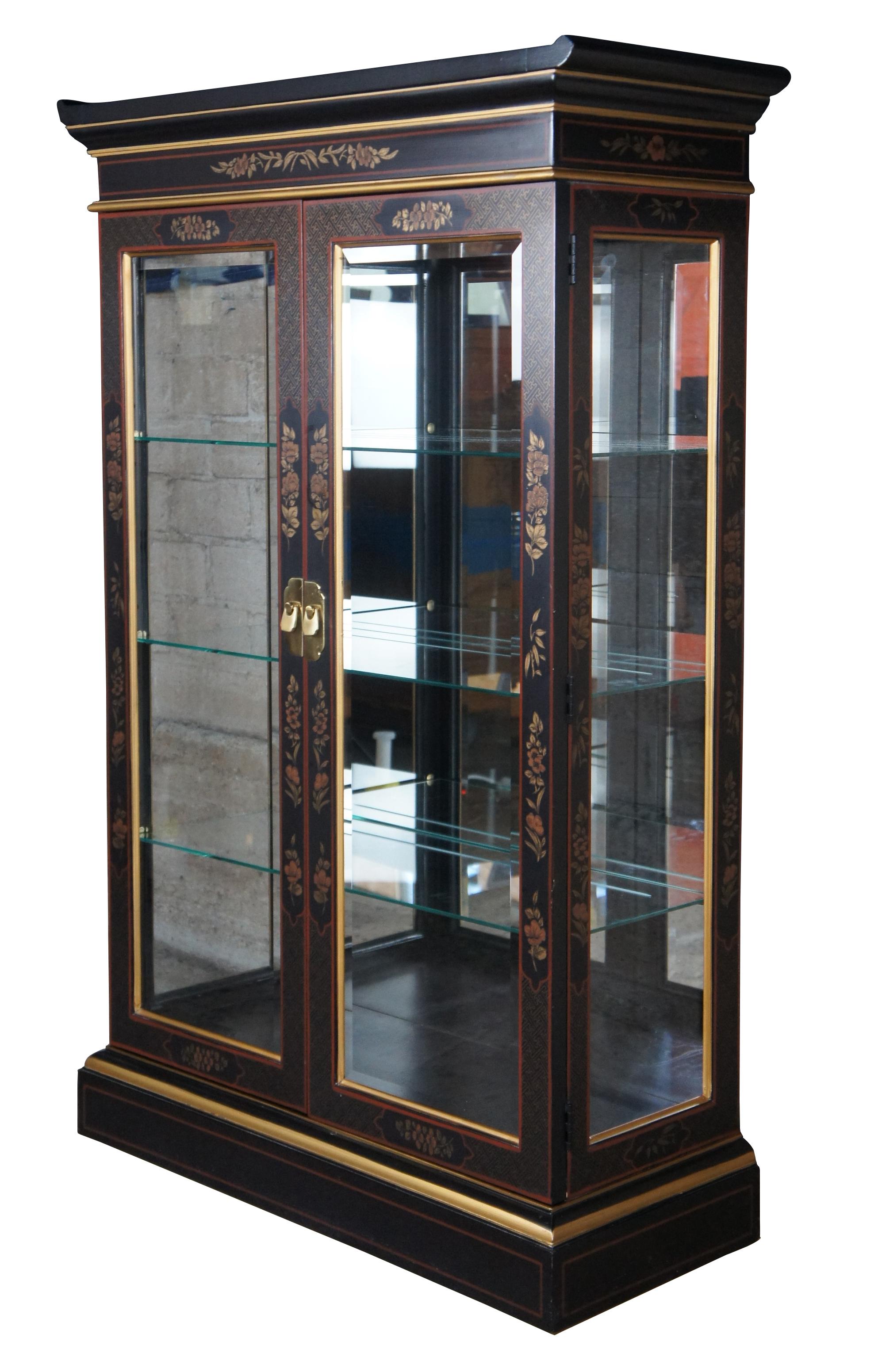 Vintage Drexel Et Cetera illuminating oriental pagoda form curio display cabinet, circa 1980s. Features black lacquer finish with gold, floral and geometric puzzled design. Includes three adjustable interior shelves with plate groves. Great for
