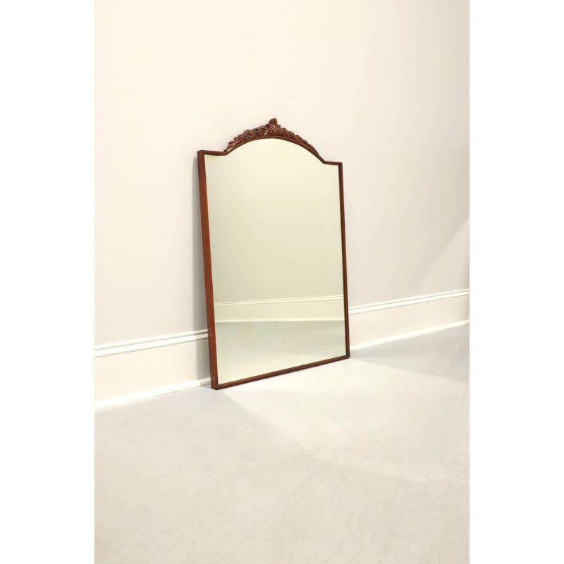 A French Provincial style wall mirror by Drexel. Made in North Carolina, USA in the mid-20th century. Mirrored glass, mahogany frame with carved floral and leaves motif at top.

Measures: 26 W 1.5 D 37.25 H, Weighs Approximately: 30
