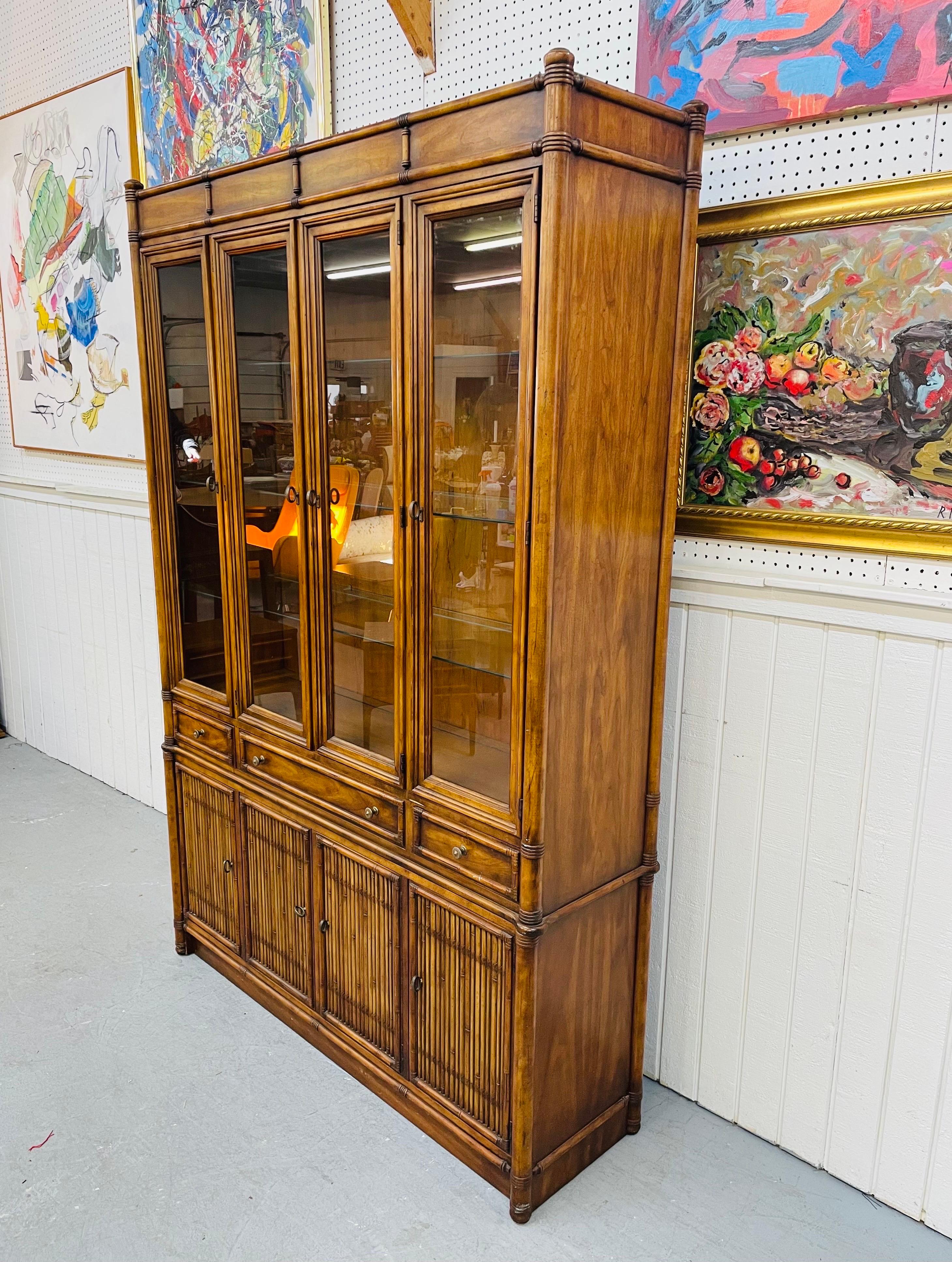 This listing is for a vintage Drexel Heritage Bamboo Style Walnut Breakfront. Featuring four glass doors that open up to three glass shelves, four wooden doors with reeded fronts that open up to storage space, original hardware, a bamboo style