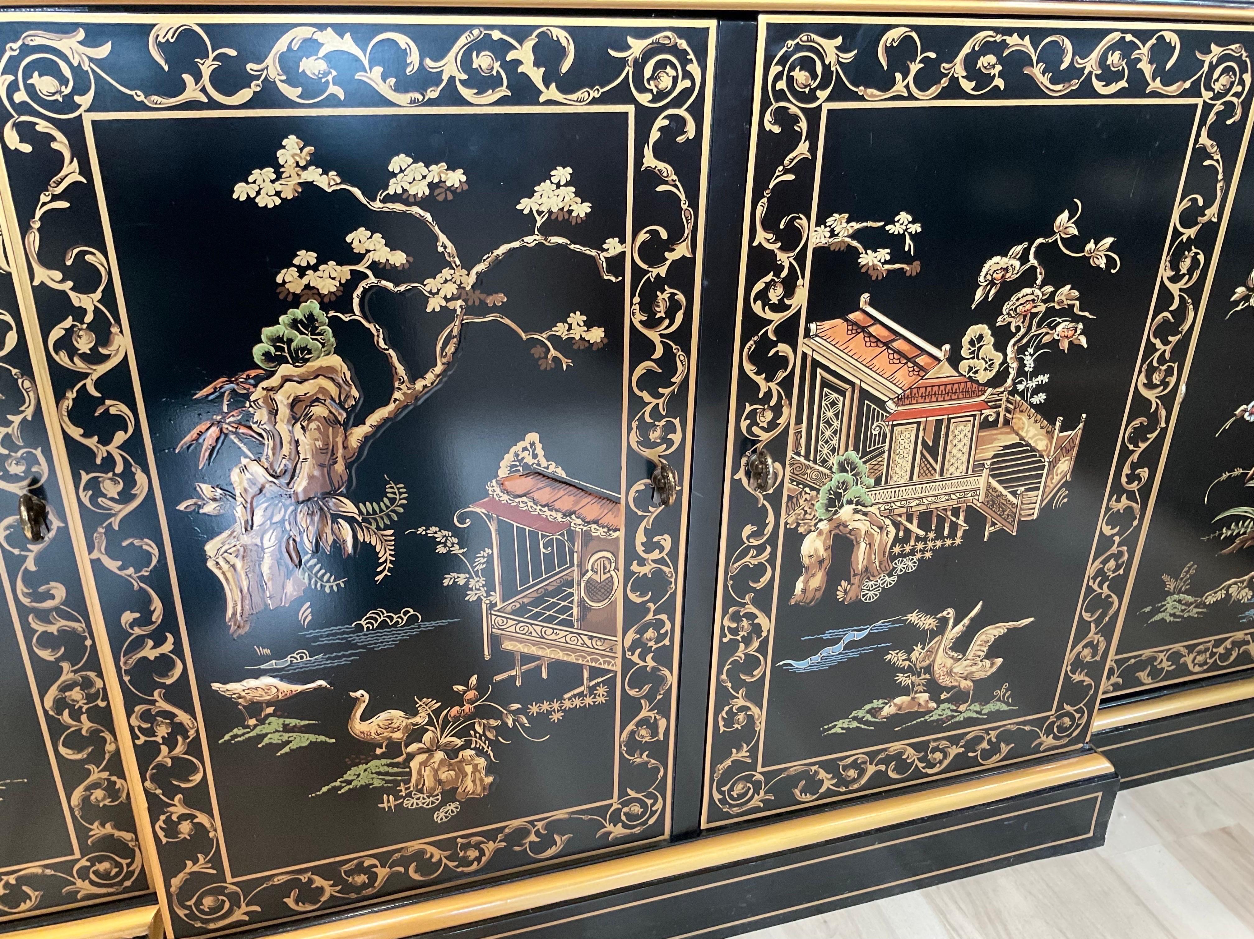 Beautiful and Rare black lacquered Sideboard with artist hand painted Chinoiserie Scenes by Drexel Heritage. Drexel was one of the few premier American Furniture Maker's with a dedicated line of Chinoiserie Furniture. The collections are some of the