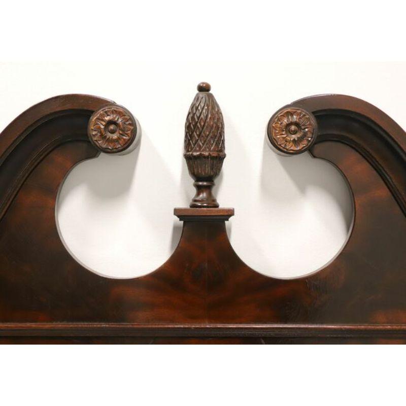 A large Chippendale style wall mirror by Drexel Heritage from their Heirlooms Collection. Made in Drexel, North Carolina, USA, in the late 20th Century. Bevel edge mirrored glass, crotch mahogany frame with decorative carving to bottom and pediment