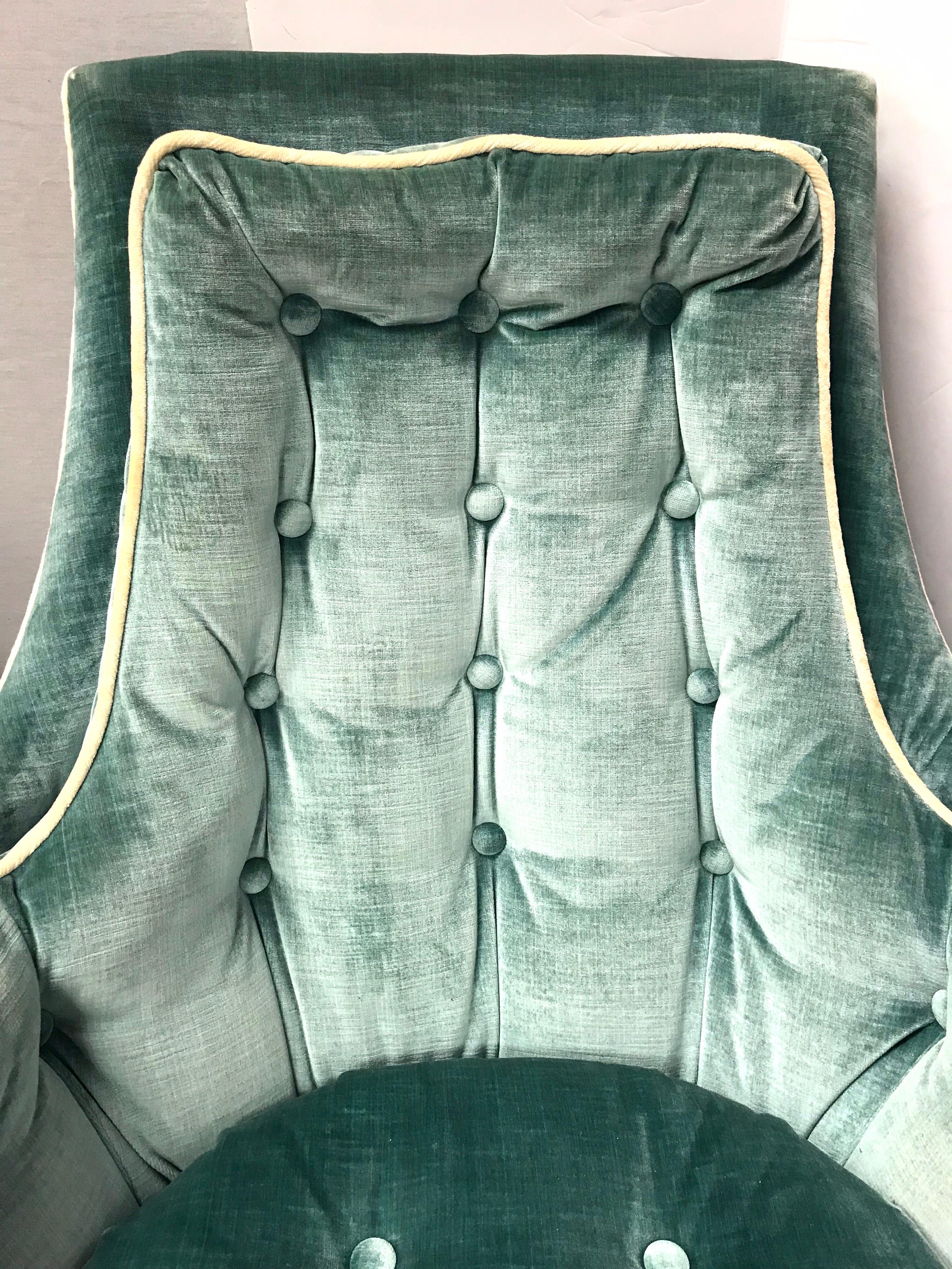 Midcentury 1960s velvet lounge chair with button tufted back and tufted seat in a beautiful robin’s egg blue color. Chair rocks and swivel 360 degrees and is super comfortable.