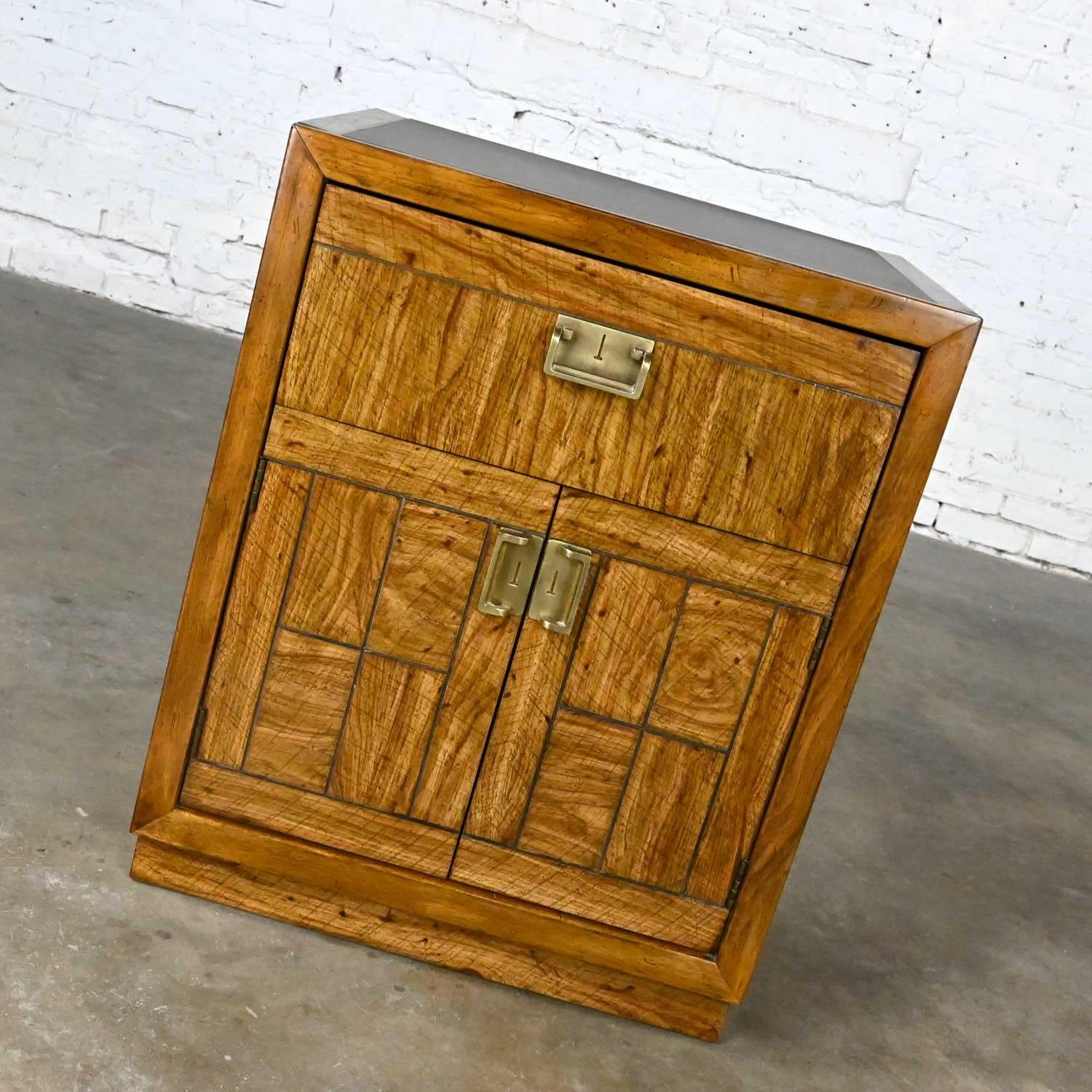 Wonderful vintage Drexel weatherwood Collection Campaign style end table, cabinet, or chest with one drawer, 2 doors with brass plated hardware, and square leather-look laminate top insert. Beautiful condition, keeping in mind that this is vintage