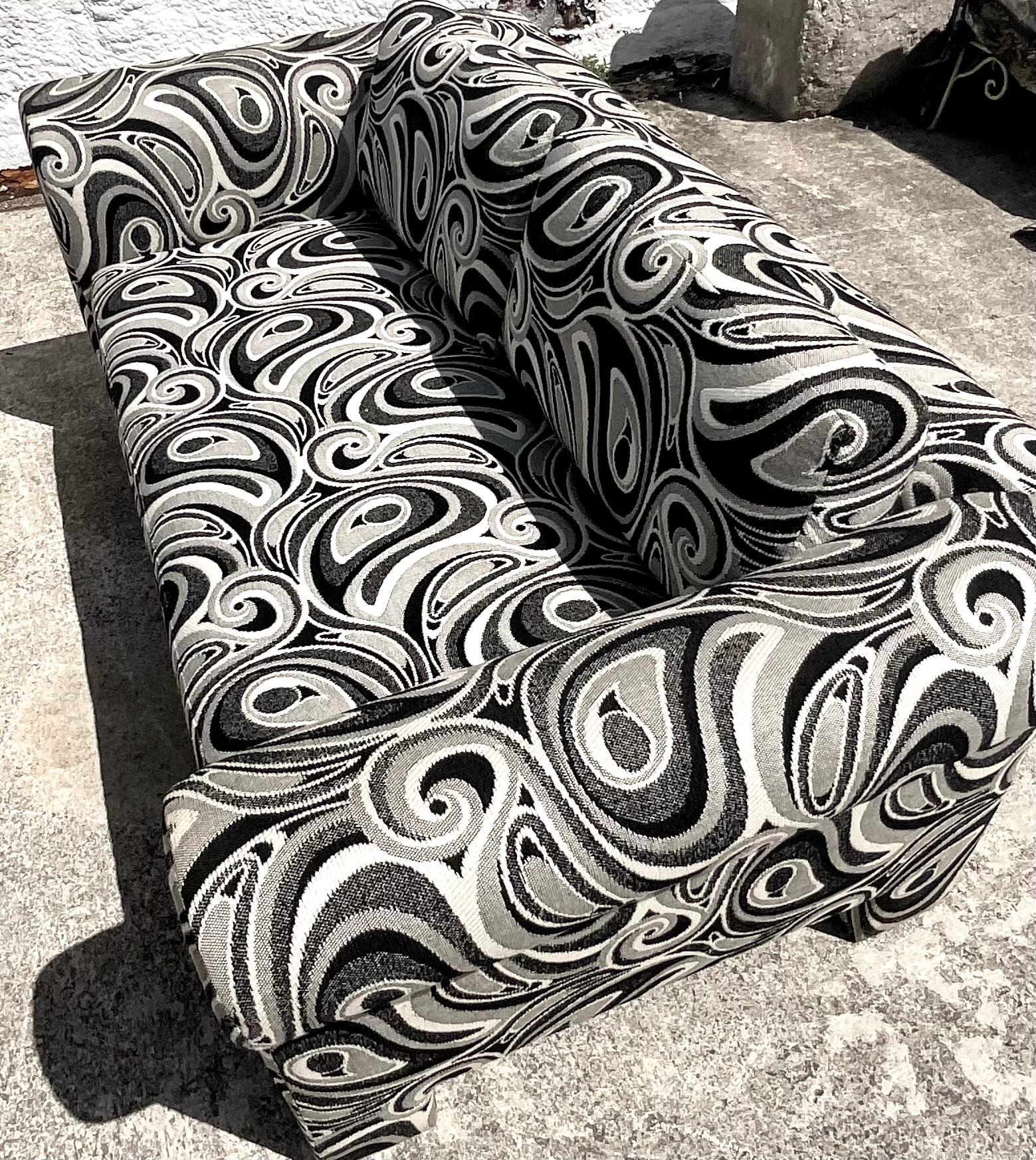 Fantastic pair of vintage Dreyfuss loveseats. A chic black and white swirl jacquard. Done in the manner of Milo Baughman. Acquired from a Palm Beach estate.