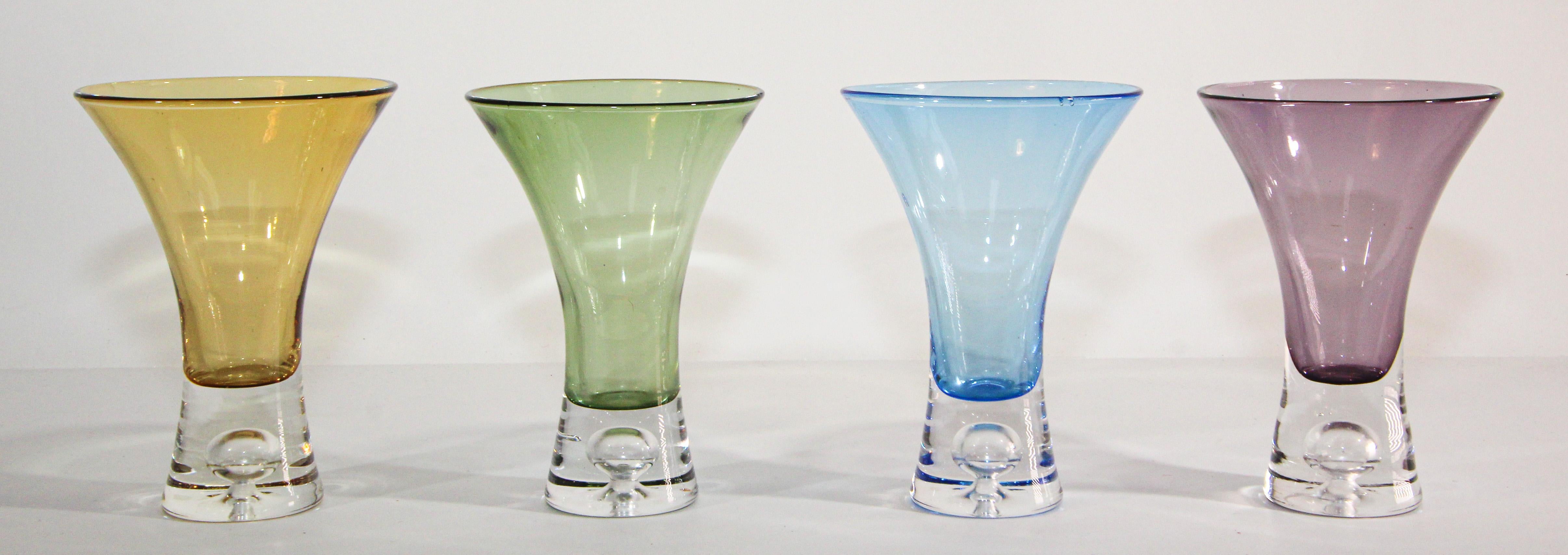 Beautiful Vintage Post Modern liquor Cordial shot drinking crystal glasses set of 4.
This set of four glasses boasts exquisite craftsmanship and distinctive color, each piece is different color, amber, pink, blue and jade green with a bubble in the