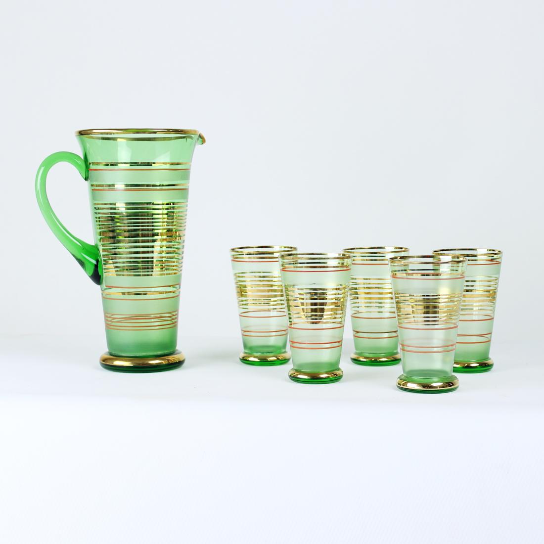 Beautiful mid-century modern design set of drinking glasses with a pitcher. Produced in Czechoslovakia by Borske Sklo, glass union in 1968. The set is in the most wonderful finish with green, red and gold finish on the design. The gold is real gold