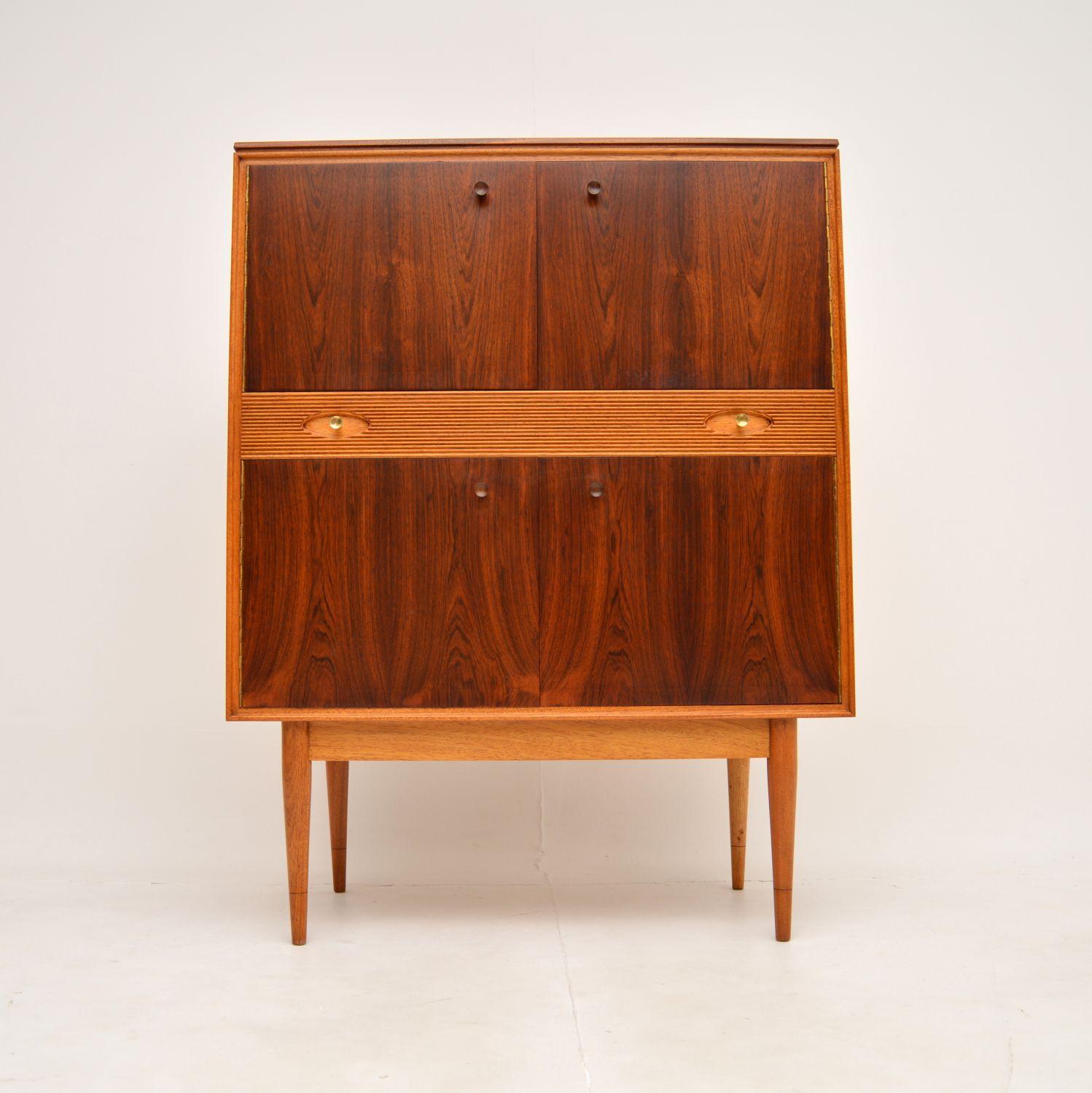 A stunning vintage drinks cabinet by Robert Heritage for Archie Shine. This is part of the award winning Hamilton range, and it dates from the 1960’s.

The doors have gorgeous grain patterns and a beautiful colour. The drawers and carcass are in a
