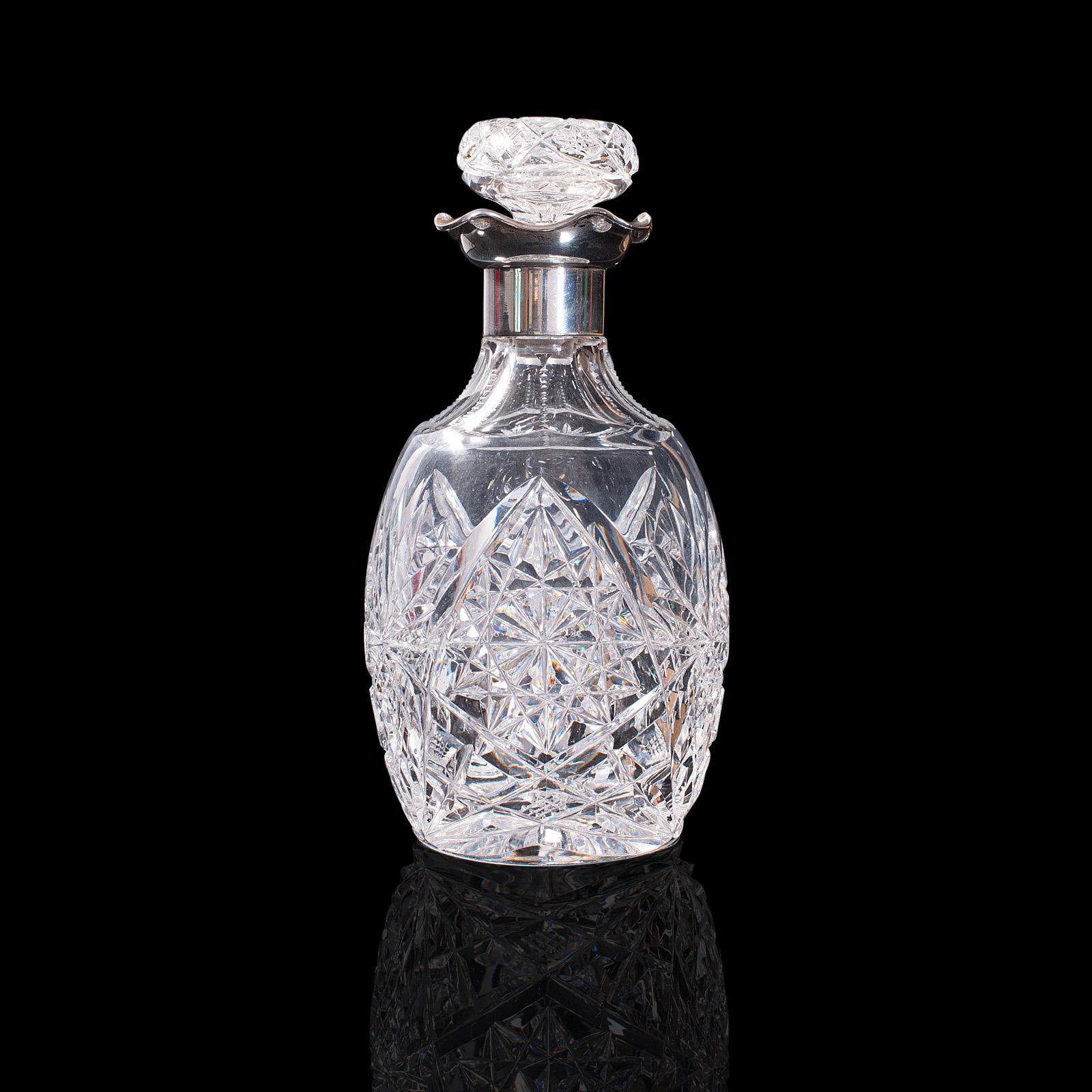 This is a vintage decanter. A German, cut glass and Continental silver whiskey or liquor vessel, dating to the late 20th century, circa 1970.

Strikingly cut and of appealing translucence
Displays a desirable aged patina and in good order
Clear,