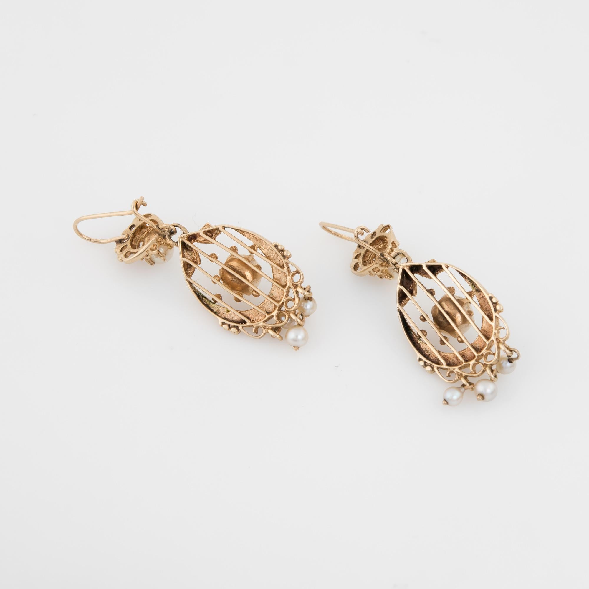 Finely detailed pair of vintage cultured pearl drop earrings, crafted in 14k yellow gold. 

A total of 10 cultured pearls range in size from 2.75mm (6) to 4.5mm (2) and 6mm (2).  

The charming earrings feature an ornate design with a fringe of