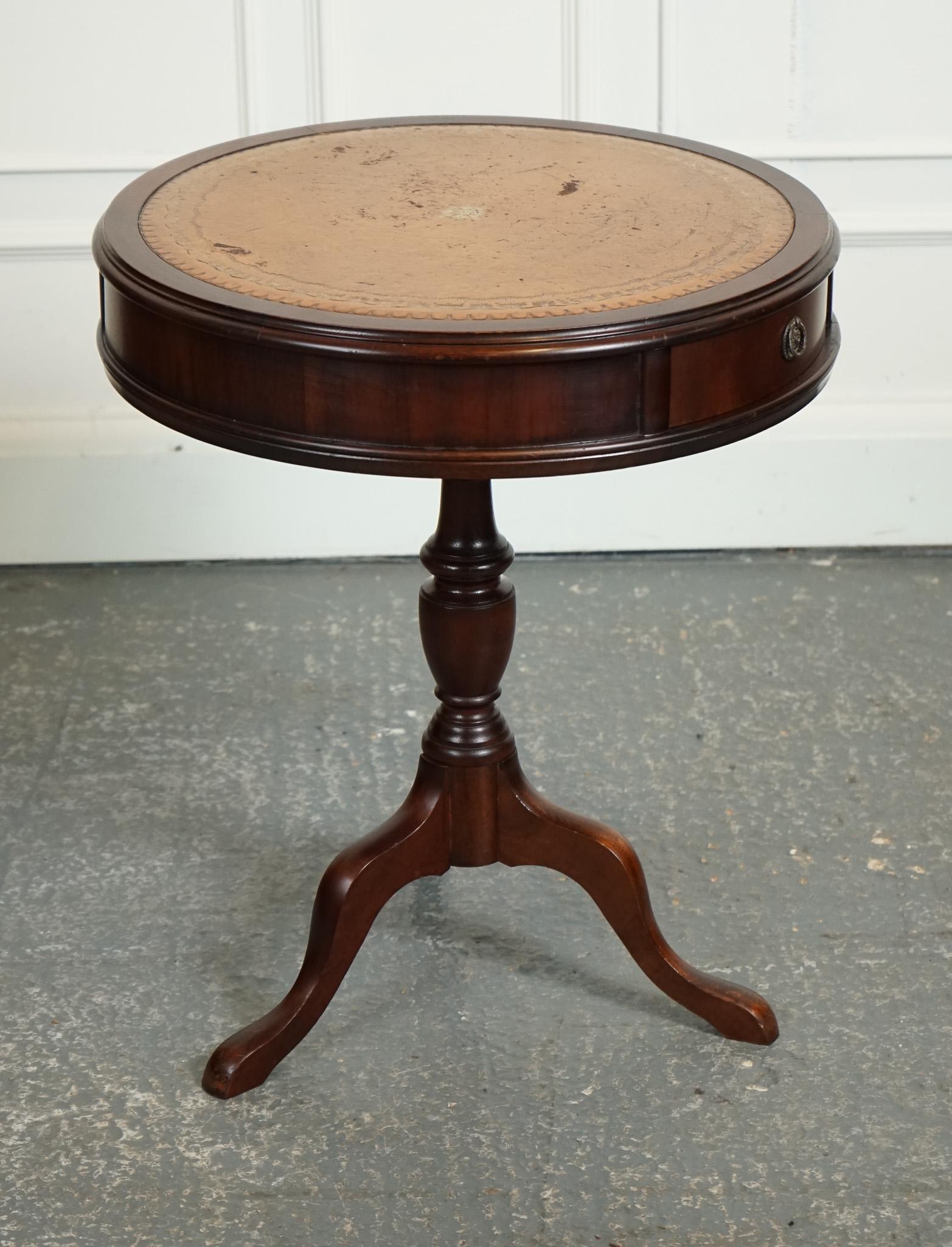 
We are delighted to offer for sale this Vintage Drum Side End Table Lamp And Wine Table Features.

 A charming blend of functionality and style. With a distinctive brown leather top, this piece exudes a warm and inviting appeal that adds character