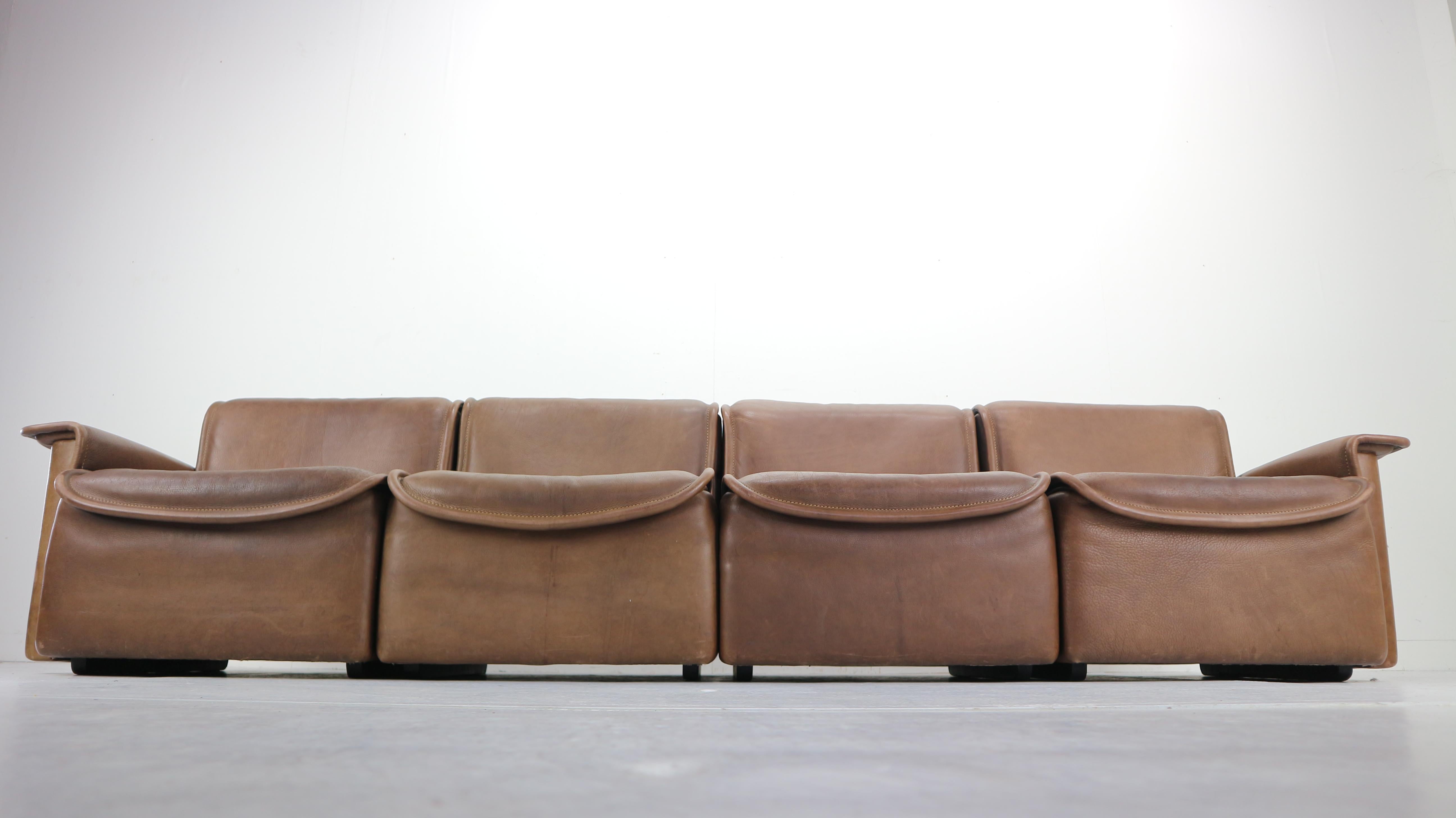 Rare four-seat sofa model DS-12 designed by design team at De Sede. Produced by De Sede in Switzerland in 1970s.
The sofa seating is made of thick brown leather and consists of four easily movable peaces.
Scandinavian Modern design.

 