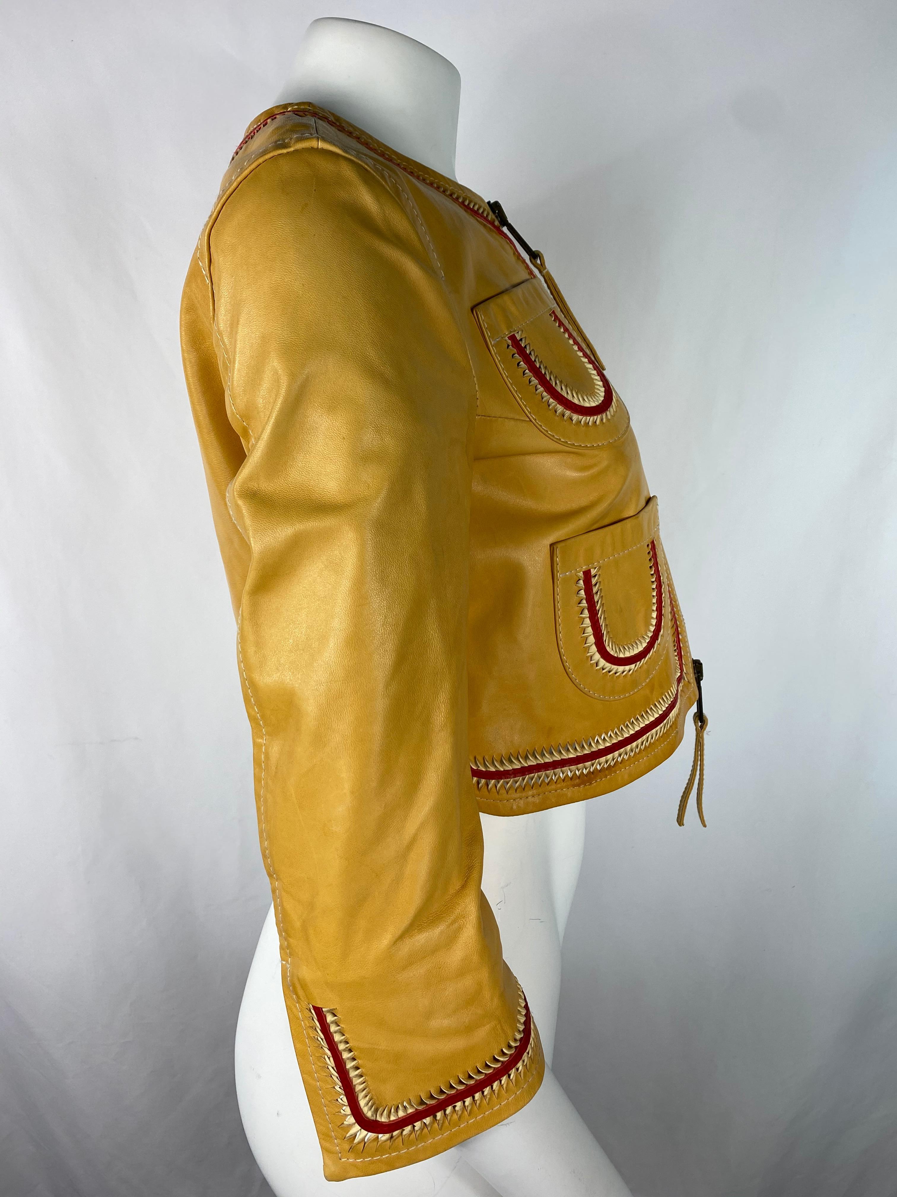 Product details:

Featuring yellow leather jacket with red detail, four front pockets, front zip closure, crew neckline, 3/4 sleeves with slit detail, cropped length. The sleeves measure 18.5 inches long.
Made in Italy.