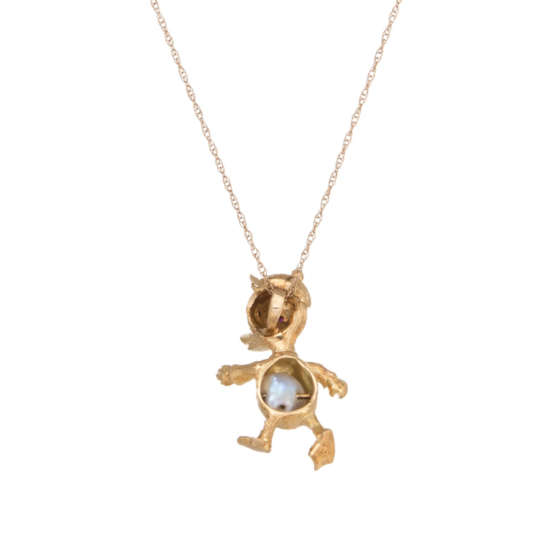 Finely detailed vintage duck pendant & necklace, crafted in 18 karat yellow gold (duck) and 14 karat yellow gold (necklace).  

A 6mm cultured pearl is set into the ducks belly. Two estimated 0.01 carat cabochon cut rubies are set into the eyes. 