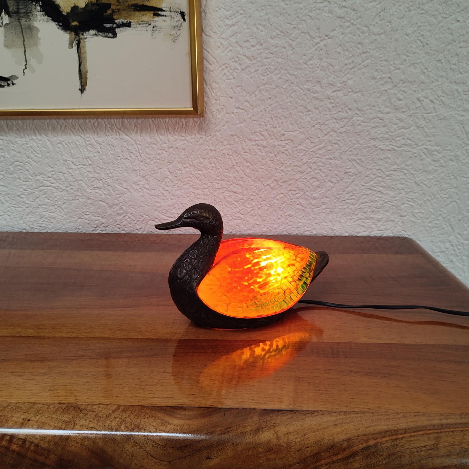 Dale Tiffany Duck Lamp. 
Beautiful and Unique Duck lamp made with amber and green glass. 
A beautiful addition to any home decor.
Superb craftsmanship and techniques for producing the rare and exotic glass of the shade. Realistic details to the