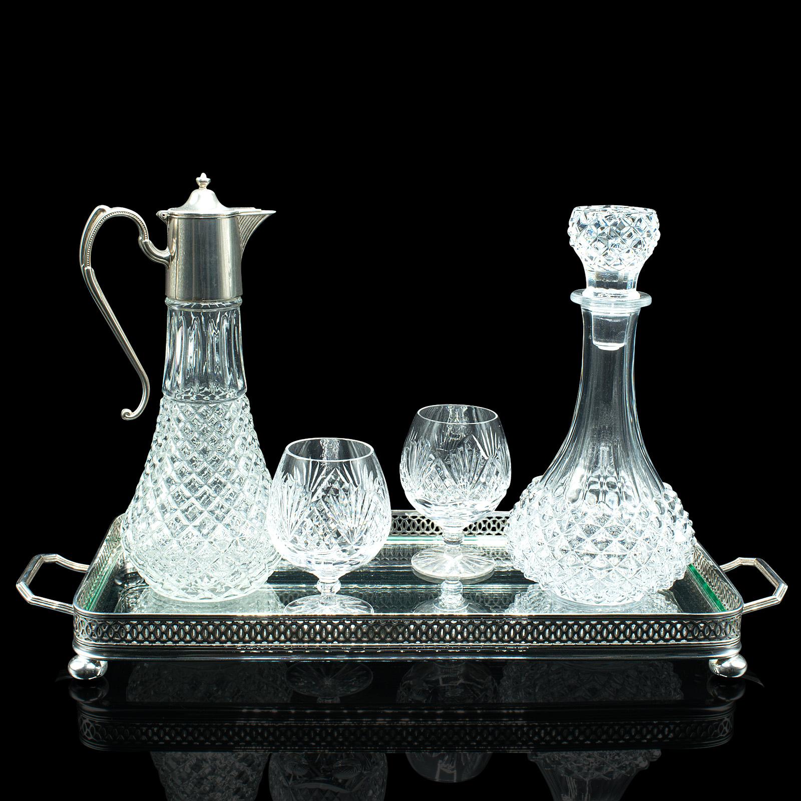 This is a vintage duet spirits tray. An English, glass and silver plate serving tray with decanters and glasses, dating to the late 20th century, circa 1970.

Striking gallery tray and cut glass service for two
Displays a desirable aged patina