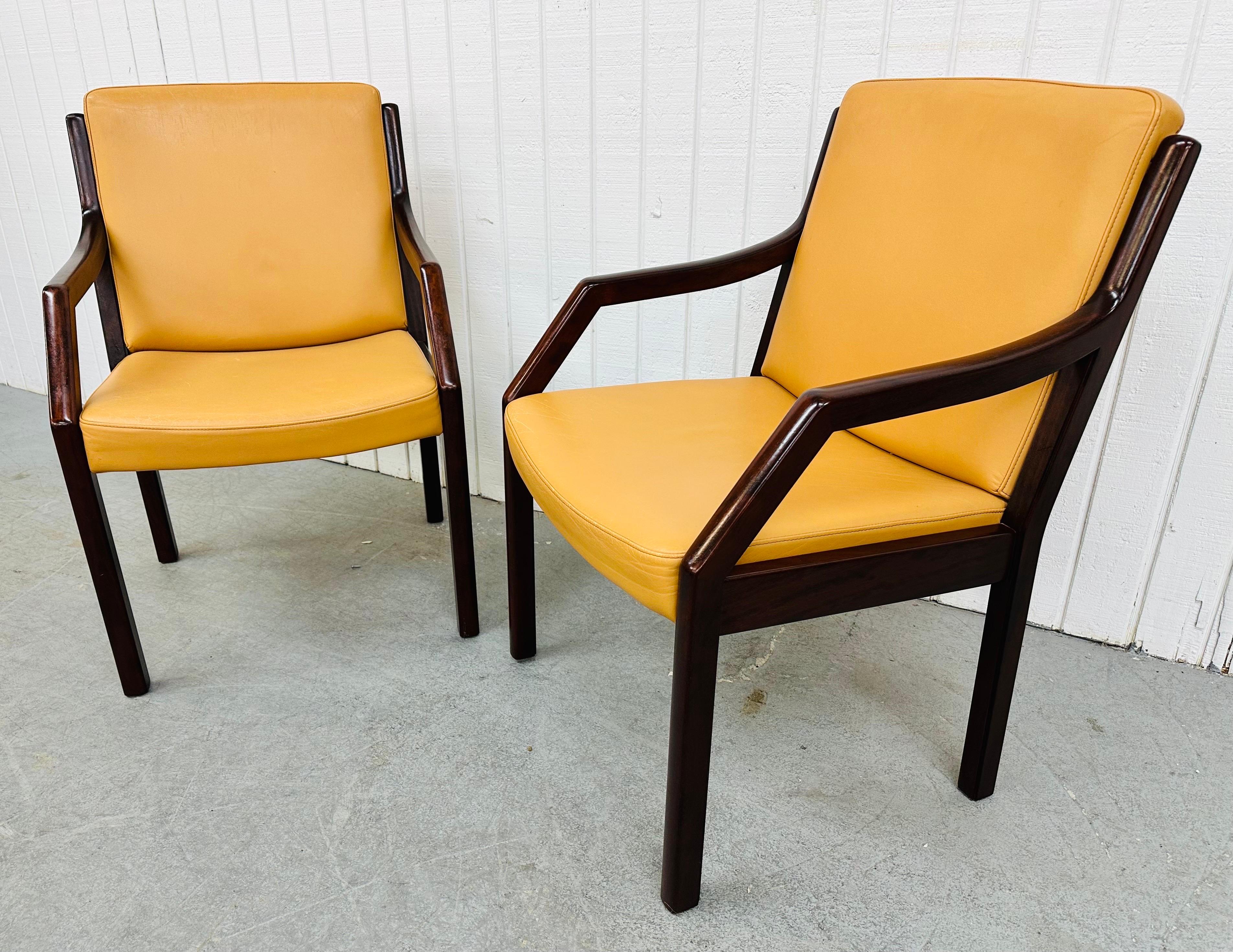 This listing is for a pair of vintage Dunbar Lounge Chairs. Featuring wooden frames, bent arm design, modern legs, golden leather upholstery, and a dark mahogany finish. This is an exceptional combination of quality and design by Dunbar!
