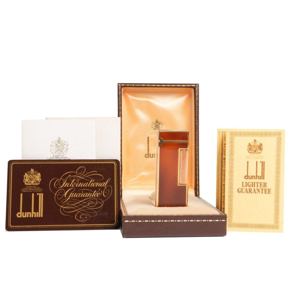 Elegant and sophisticated vintage gold plated 70s Dunhill Rollagas S Lighter in glossy brown lacquer. The lighter comes with the original brown box including all the documents (certificate, instructions for use, lighter guarantee, and a guarantee
