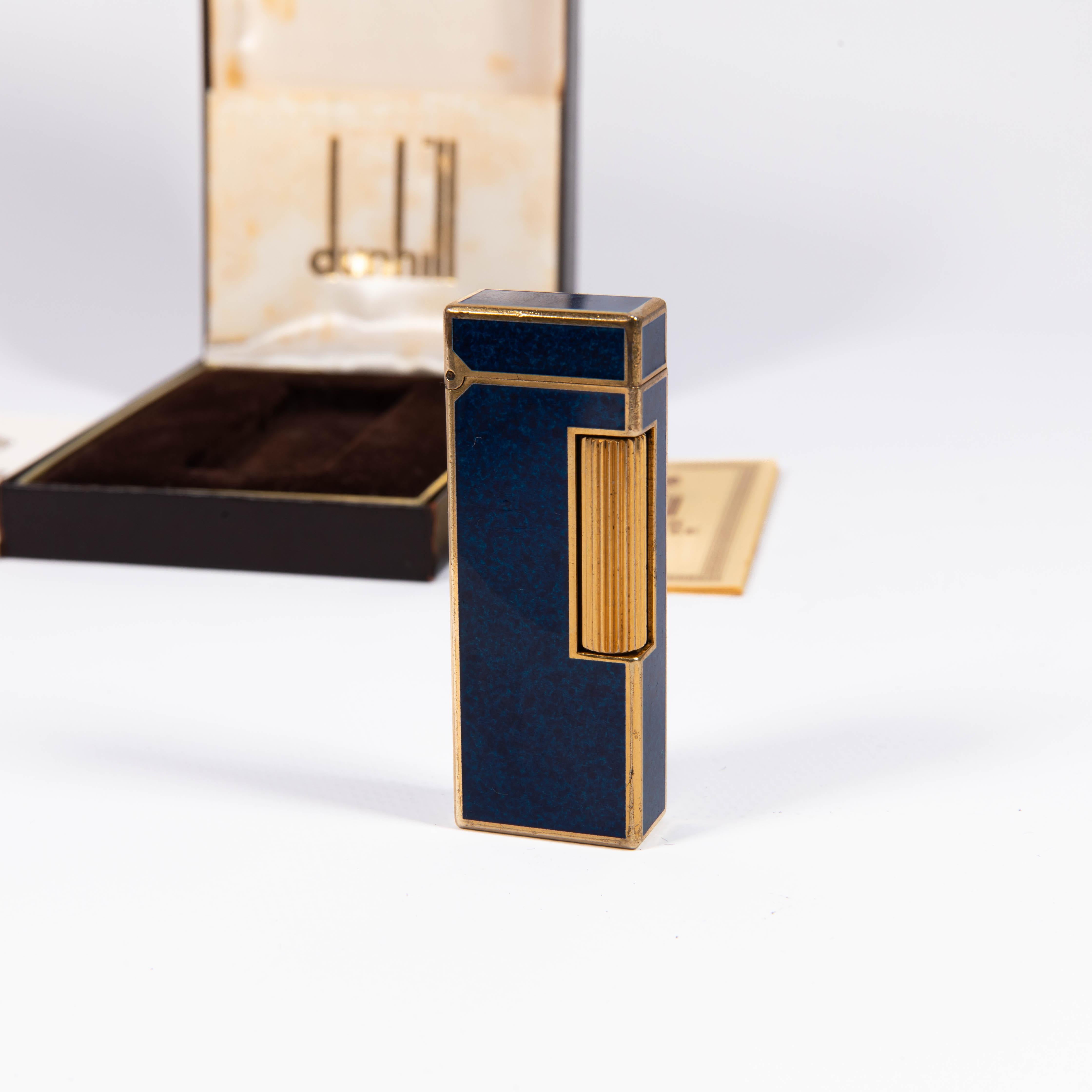Vintage Dunhill Rollagas lighter Lapiz Lazuli Gold Plated In Box 1980s

The iconic Dunhill name is known for quality, well-made cigarette lighters and other smoking implements. The company’s origin can be traced to Alfred Dunhill opening his first