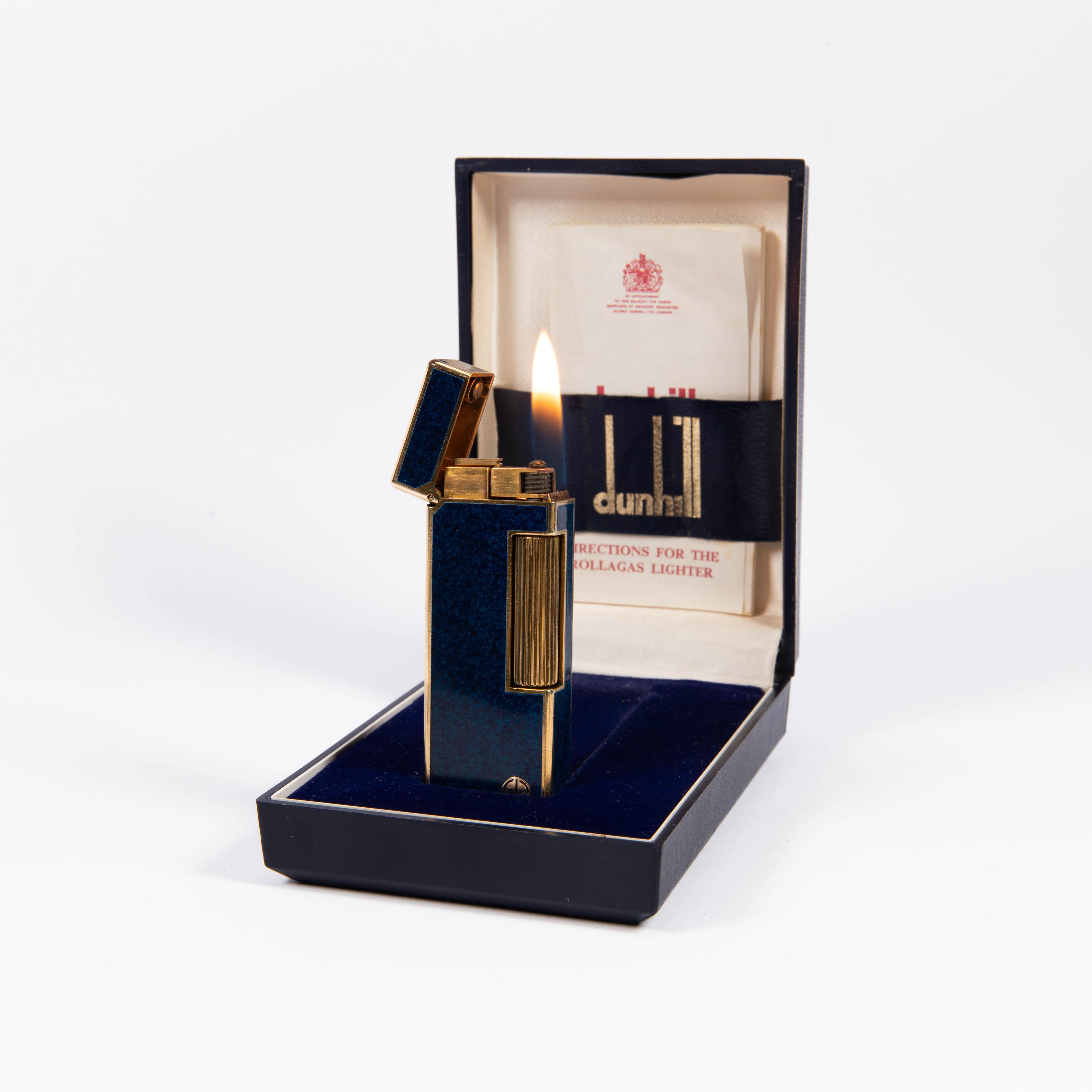 Vintage Dunhill Rollagas lighter Lapiz Lazuli Gold Plated In Box 1980s

The iconic Dunhill name is known for quality, well-made cigarette lighters and other smoking implements. The company’s origin can be traced to Alfred Dunhill opening his first