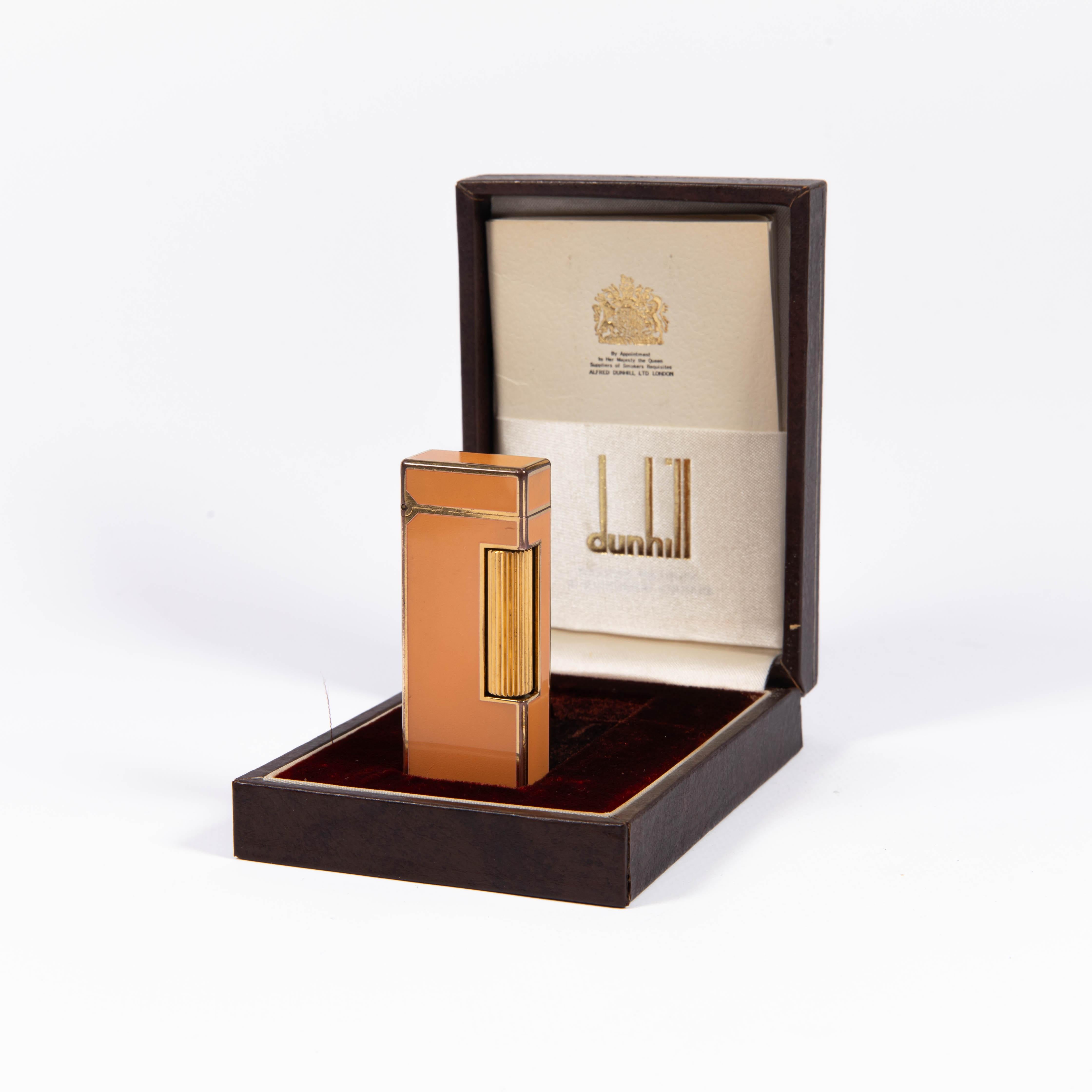 Vintage Dunhill Rollagas lighter Orange Laqcuered Gold Plated In Box 1980s

The iconic Dunhill name is known for quality, well-made cigarette lighters and other smoking implements. The company’s origin can be traced to Alfred Dunhill opening his