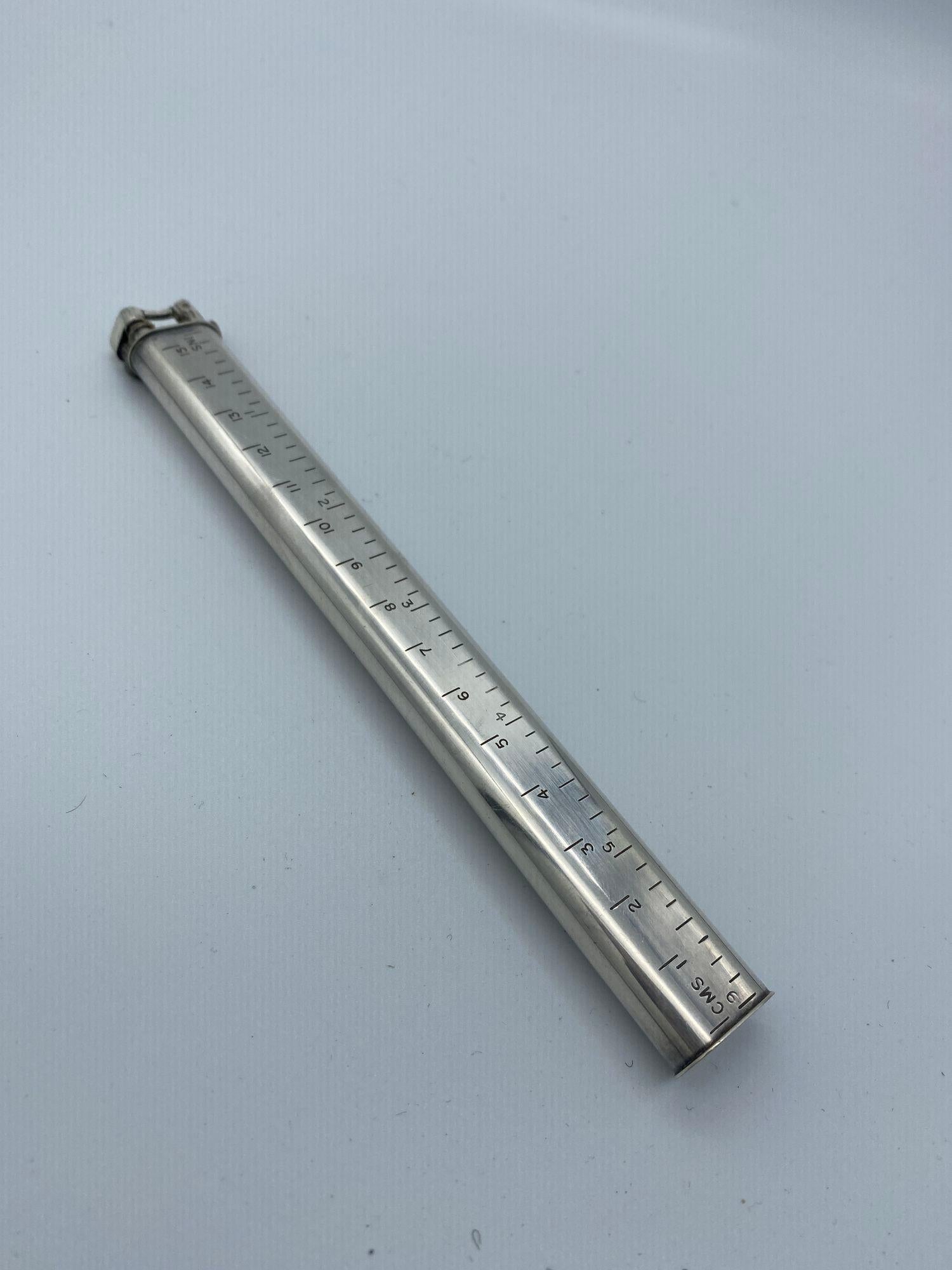 This English silver plated Dunhill Sylph Ruler lift-arm lighter is calibrated in both inches and centimetres.

Circa 1953