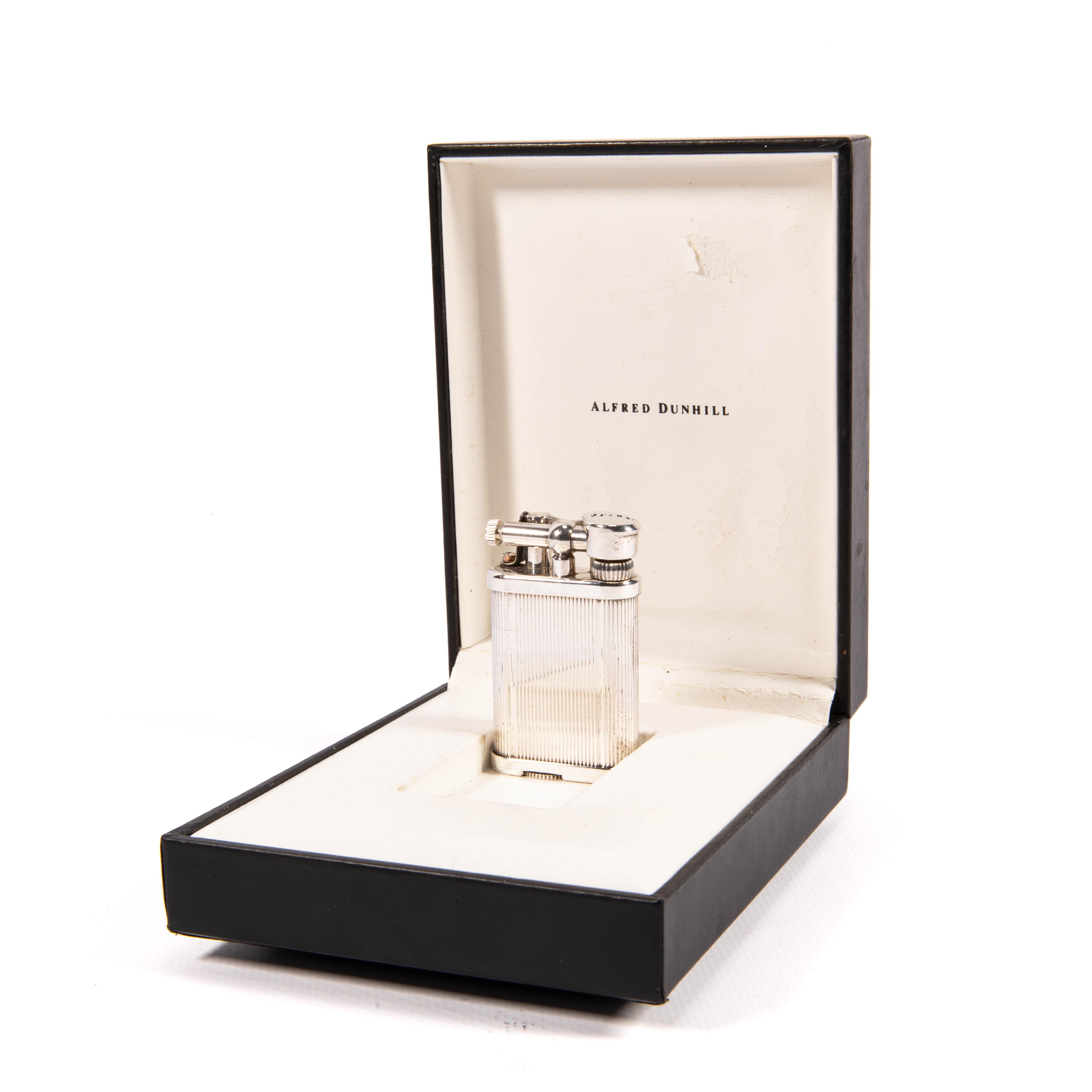 Vintage Small Dunhill Unique lighter Silver Plated Striped In Box 1970s

The iconic Dunhill name is known for quality, well-made cigarette lighters and other smoking implements. The company’s origin can be traced to Alfred Dunhill opening his first