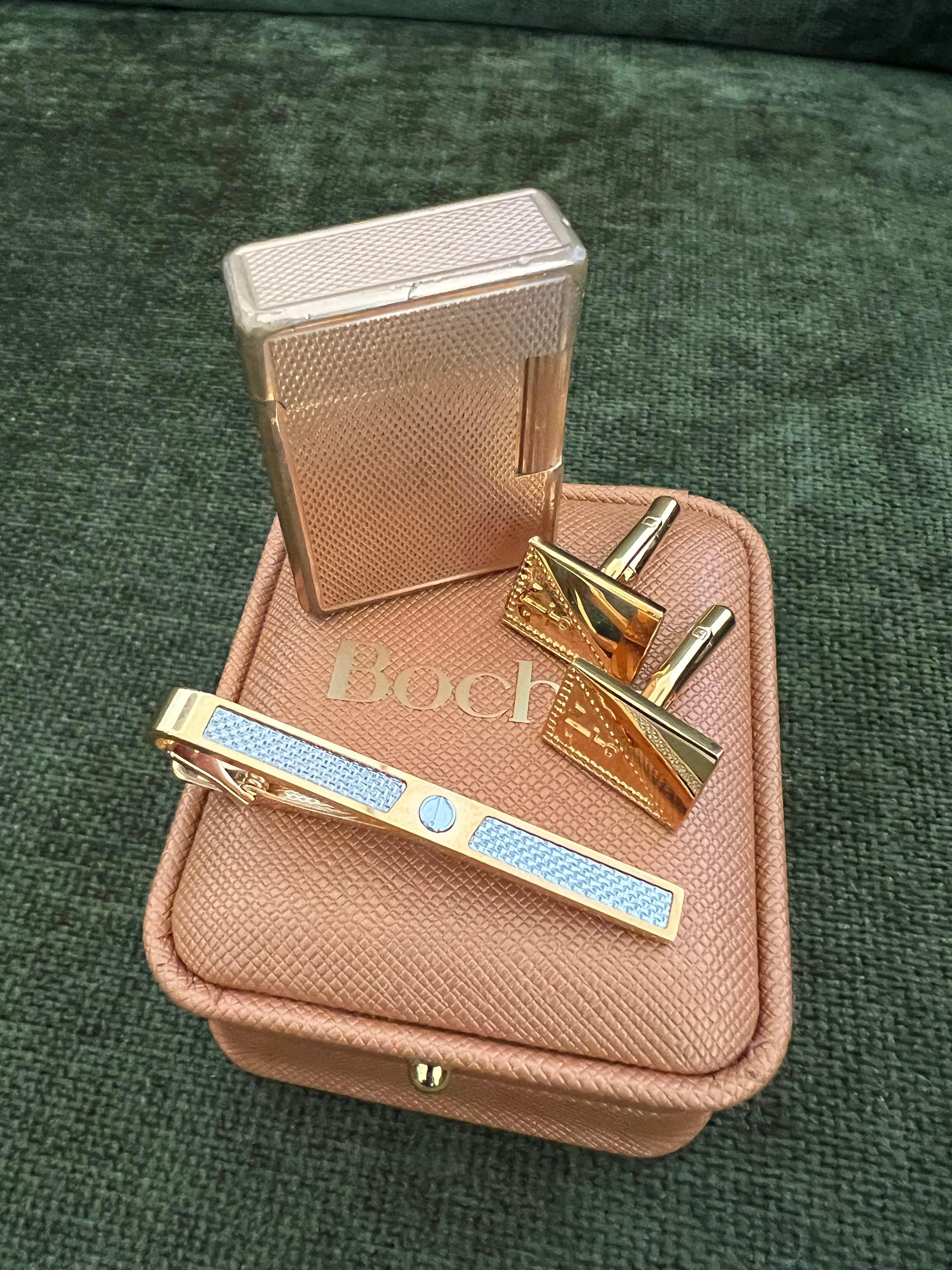 Vintage Dupont Rose Gold Plated Lighter
British Heritage Cufflinks 
& Dunhill Neck Tie Gift Set 
“Circa 1970”

Vintage Dunhill Neck Tie 
Luxury brands like Dunhill typically sell products that have high manufacturing costs. Not only do quality raw