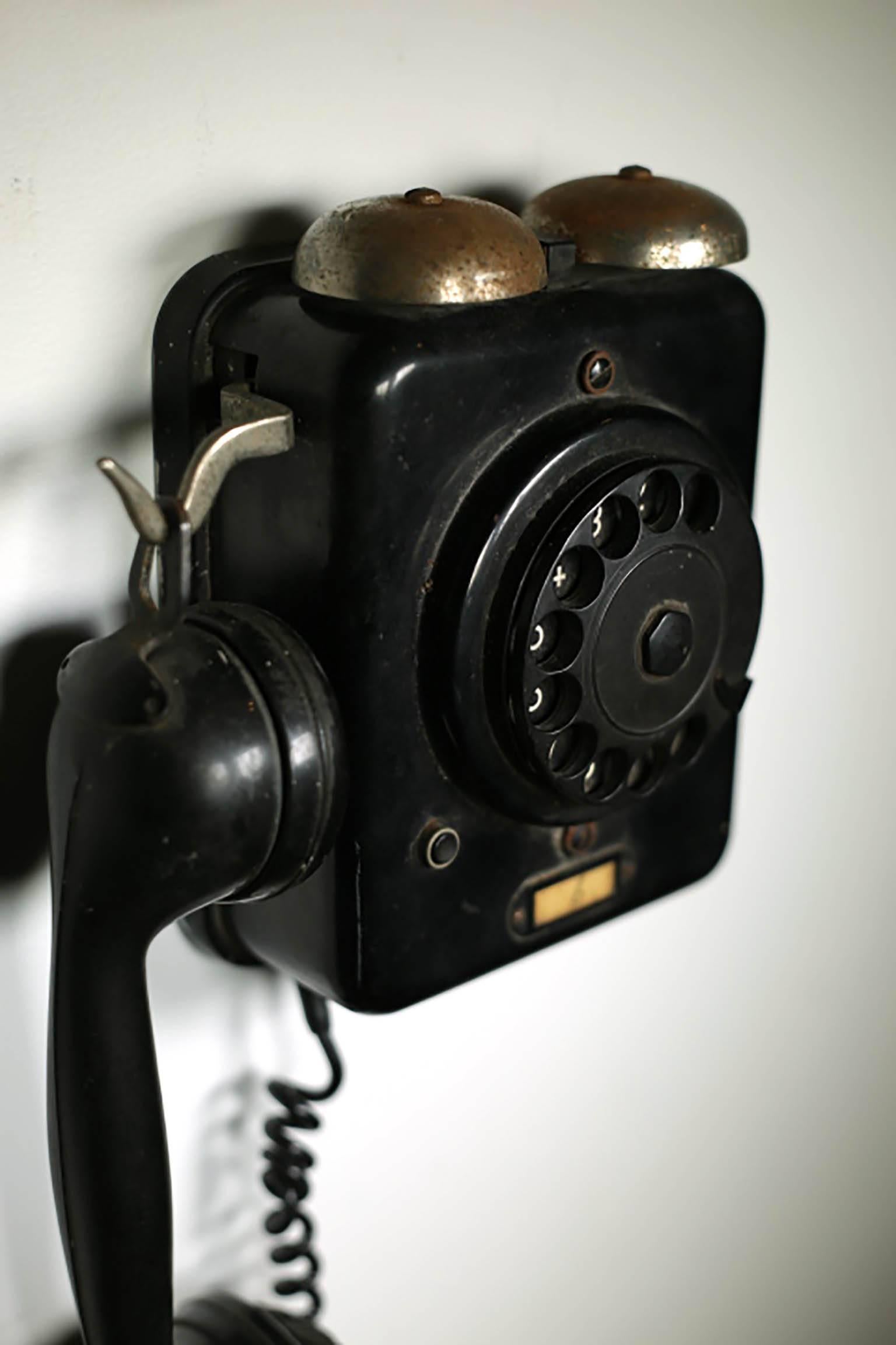 Metal body with a Bakelite rotary dial telephone, circa 1950s. Might possible work if hooked up. The dial works properly.
