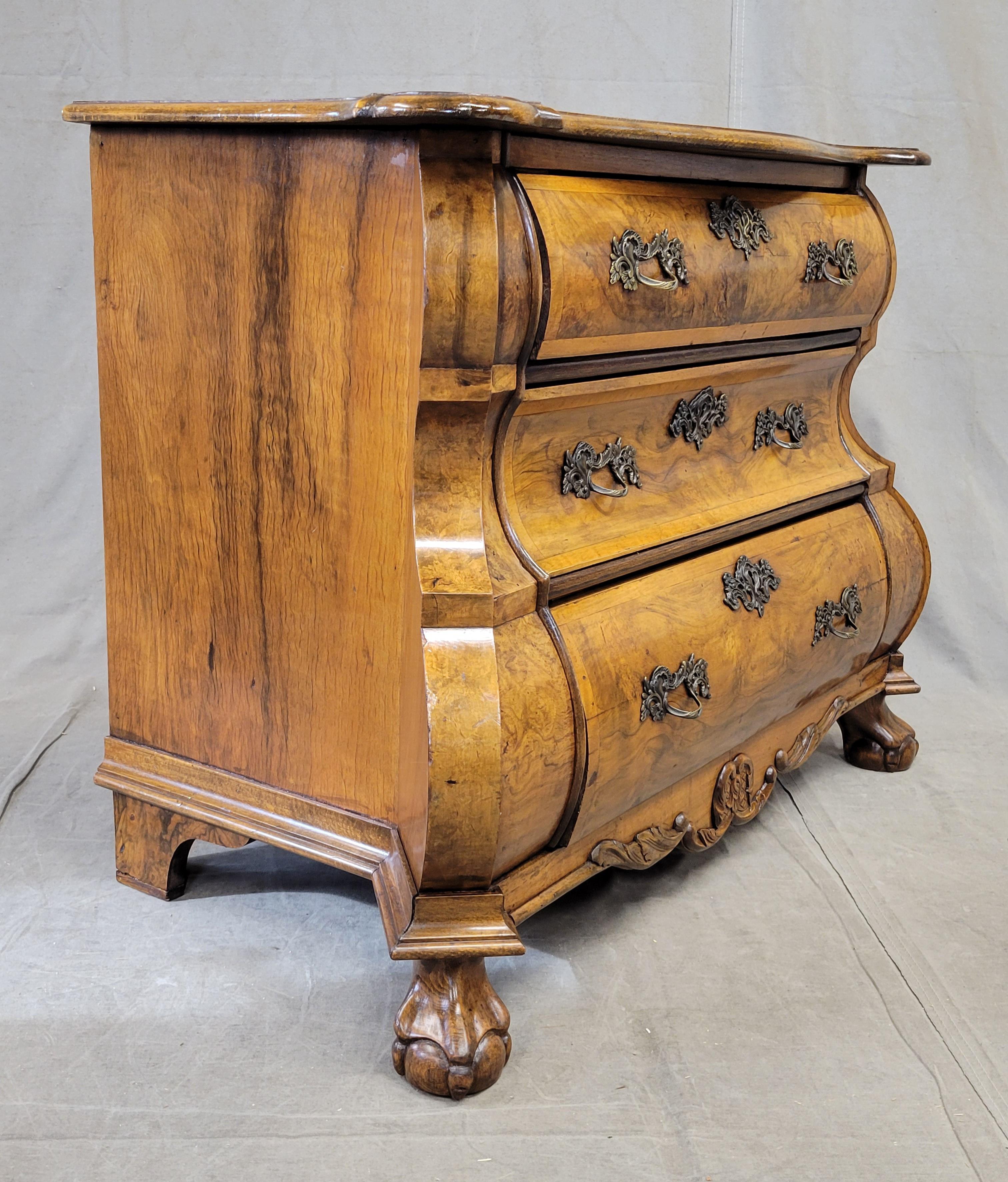 This piece is absolutely stunning! This chest of drawers appears to be vintage, made perhaps between the 1930s and 1950s, in a very traditional style by an expert craftsperson. The walnut veneer is absolutely stunning, bookmatched on the top, see