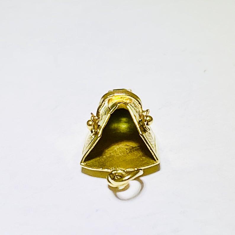This is a vintage little shoe charm that looks like a dutch clog! It is made from 18 karat yellow gold and has a genuine  green tourmaline on top of it and the tourmaline is the exact color of a green emerald. This item was handmade and is one of a