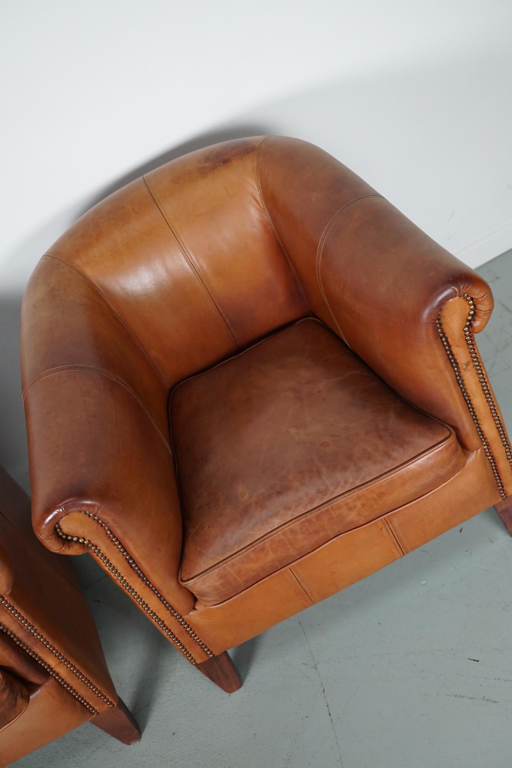 Industrial  Vintage Dutch Cognac Leather Club Chairs, Set of Three with Two Footstools For Sale