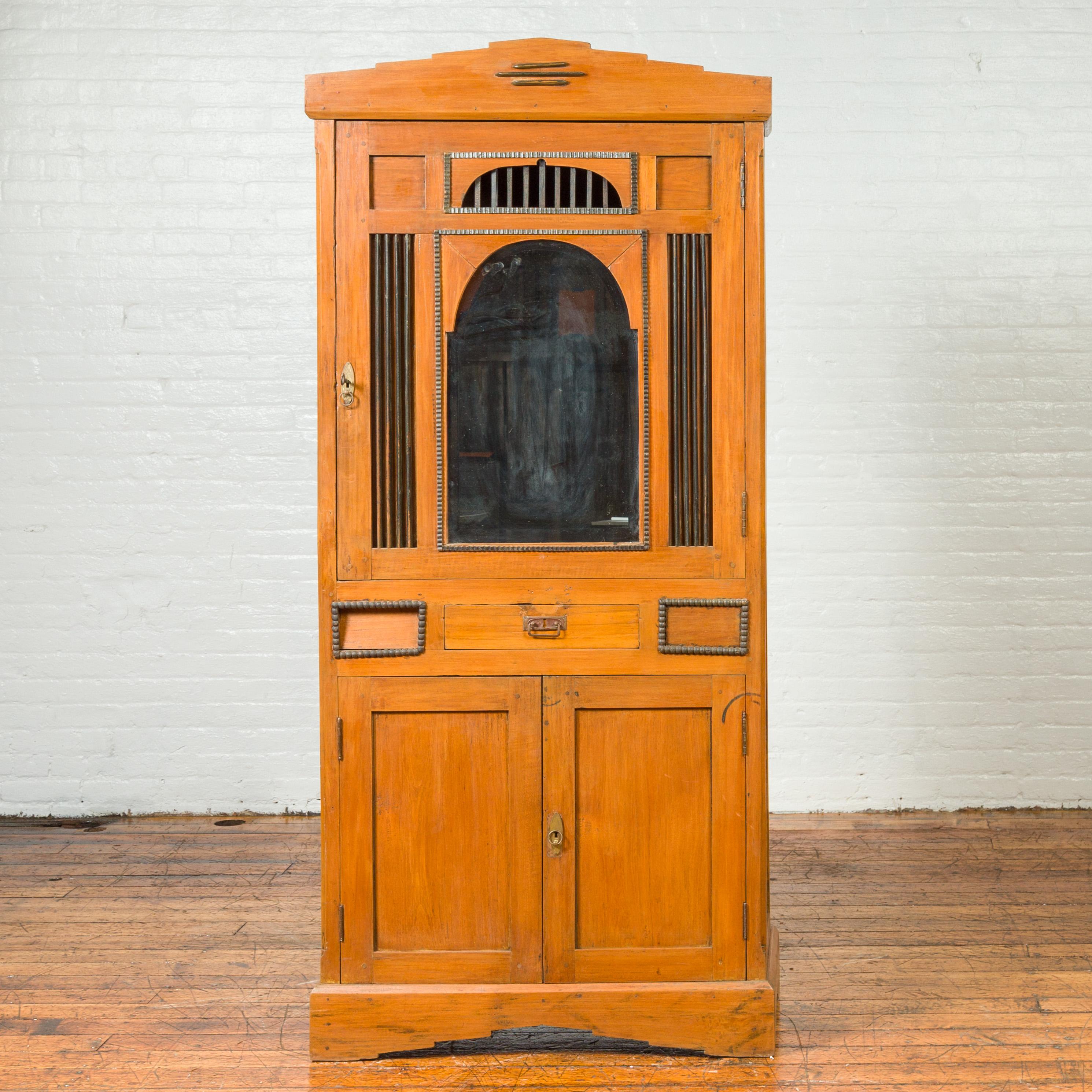 A vintage Dutch Colonial Art Deco style cabinet from the mid-20th century, with doors, drawers and mirrored front. Discover the elegant fusion of colonial design and Art Deco style with this vintage Dutch Colonial cabinet from the mid-20th century.