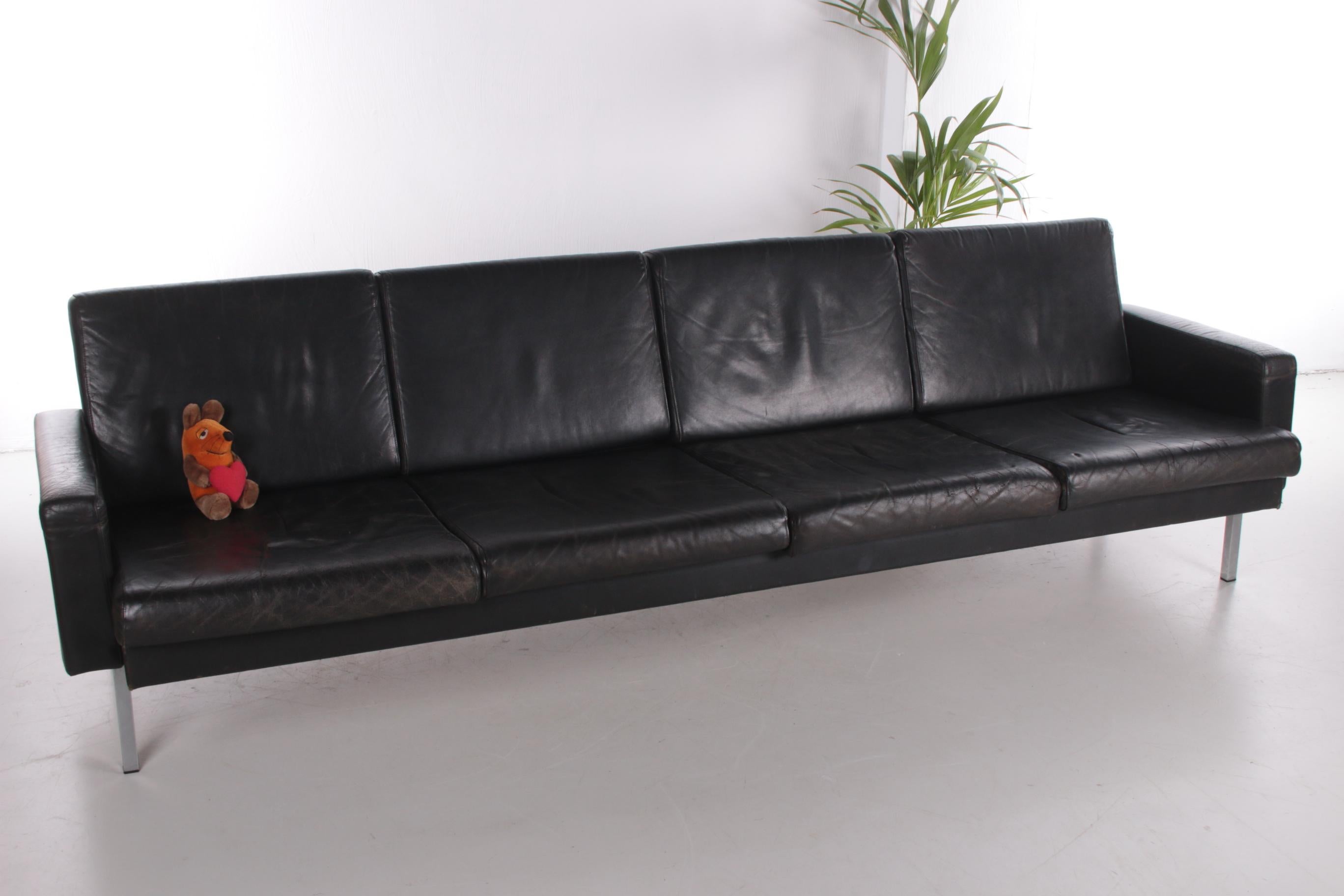 This 4-seater sofa is a beautiful design by Martin Visser.

Produced by 't Spectrum in 1968. This sofa has chromed Minimalist legs and is still equipped with original black leather cushions.

Absolutely beautiful due to the aged patina.

It is