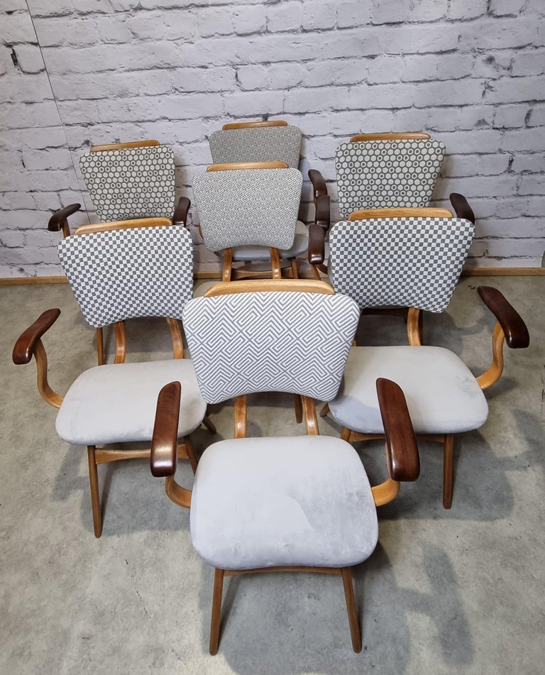 1950s chairs attributed to Cees Braakman. The elegant flowing lines are characteristic for the design of the 50's which draws its inspiration from Scandinavia. The curved armrests make the chairs very comfortable. The chairs have been reupholstered,