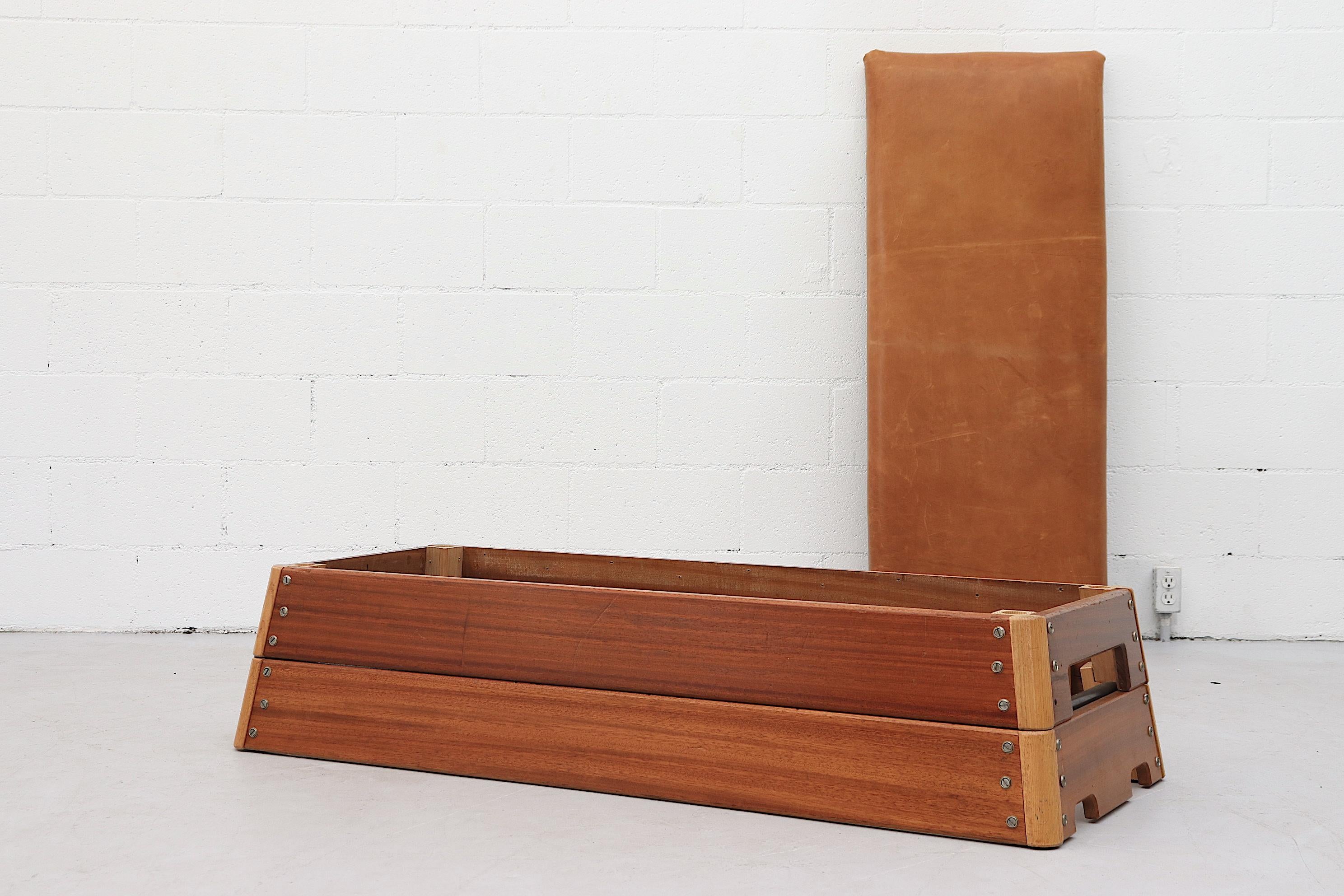 Vintage Dutch gymnastics bench repurposed to a bench or coffee table with removable new natural leather top and wood frame. In original condition with visible wear consistent with age and use. Others available in varying sizes and wear.