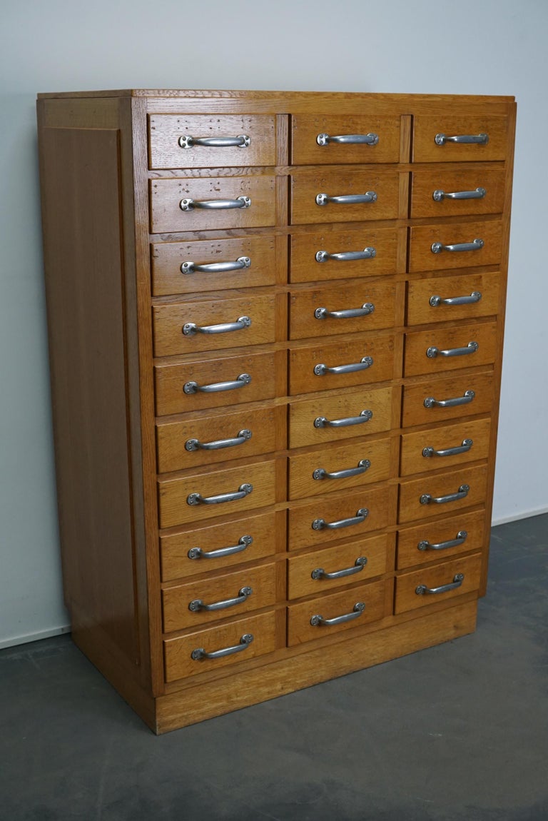 This apothecary cabinet was produced during the 1950s in the Netherlands. This piece features 30 drawers with nice metal / chrome handles. The interior dimensions of the drawers are: D x W x H 40 x 26 x 5.5 / 9 cm.