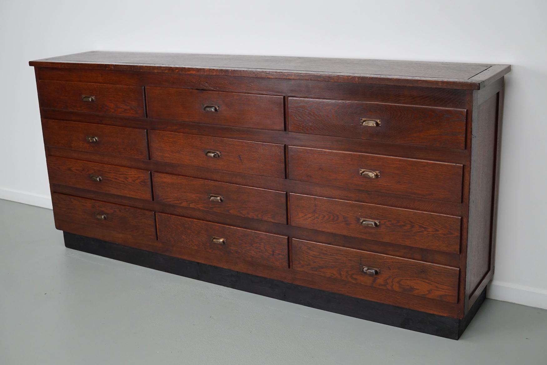This apothecary / filing cabinet was produced during the 1950s in the Netherlands. This piece features 12 decent sized drawers. The interior dimensions of the drawers are: DWH 34 x 27 x 14 / 18 cm