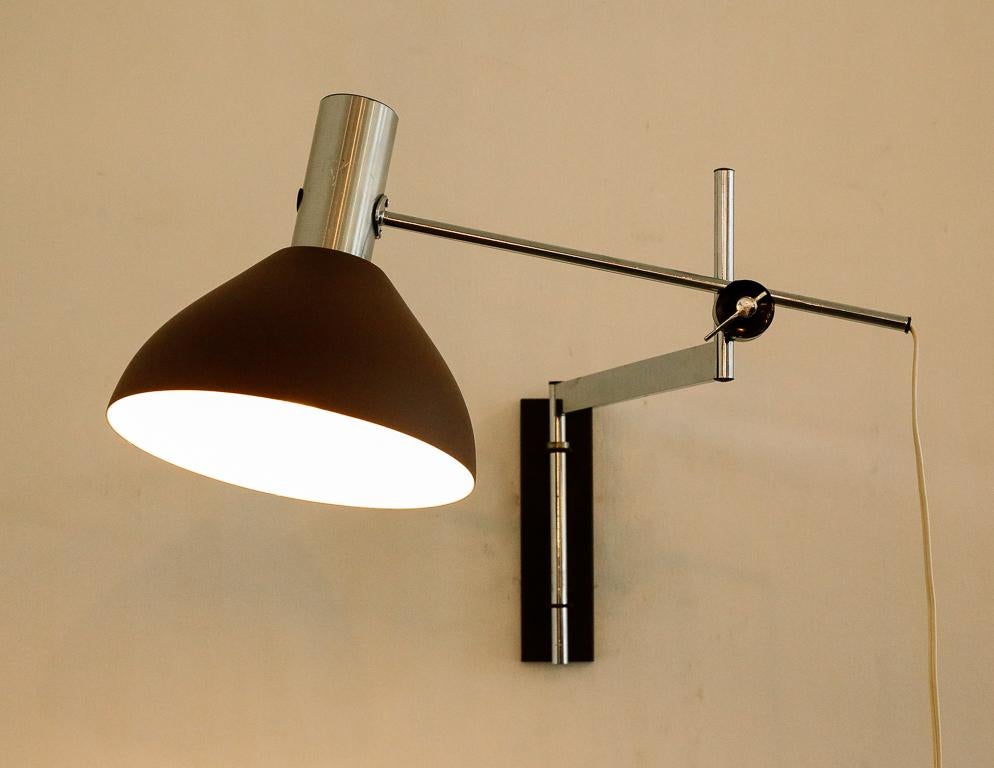 Vintage swing arm wall lamp from Holland, 1960s. Matte-brown shade and chrome arm.