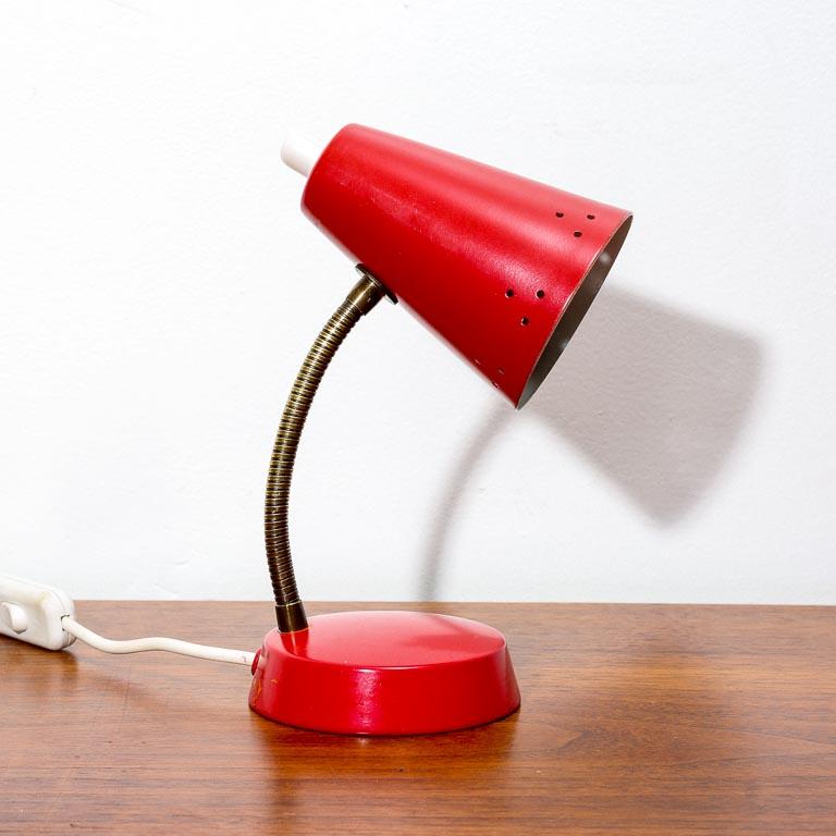 Tiny vintage Dutch table lamp in bright red with brass gooseneck. Has a keyhole on the base for wall hanging. Likely manufactured by Hala Zeist.