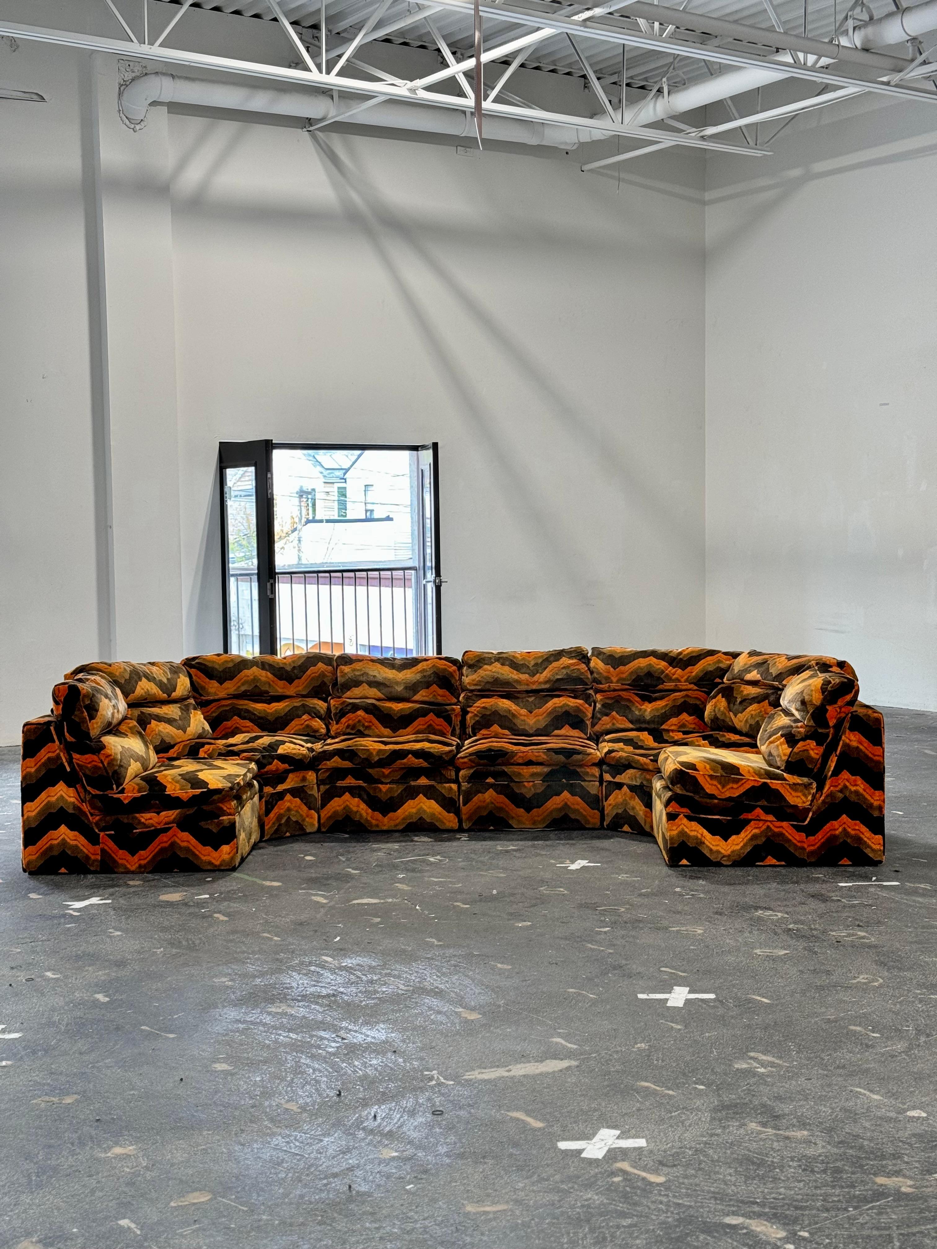 Absolutely incredible vintage 8pc modular sectional, attributed to DUX of Sweden. Stamped made in Sweden. 

Brilliant original mid-century modern upholstery. Custom abstract print with warm true-to-period colours. Composed of 6 seats, and two