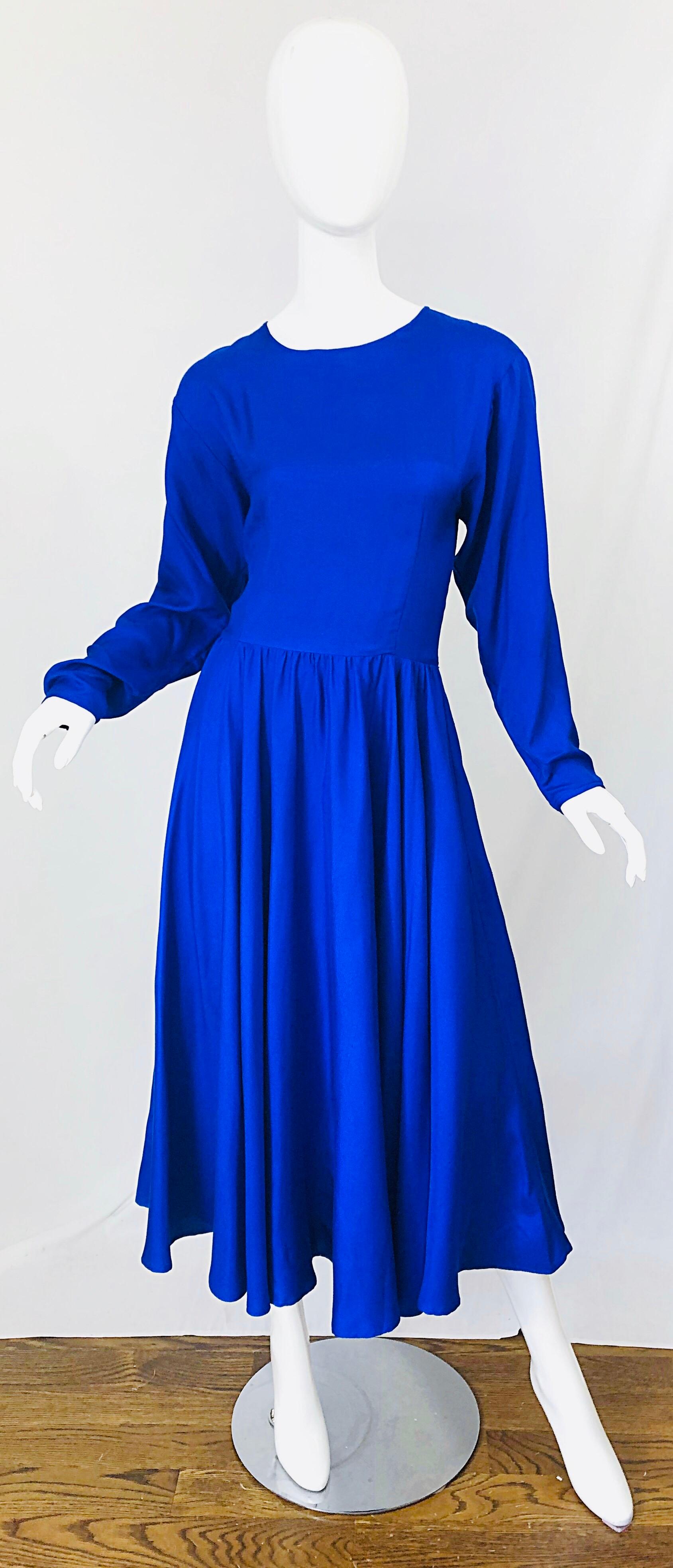 Beautiful DYNASTY royal blue late 1970s silk long dolman sleeve midi dress! Features a slight dolman sleeve that began to trend in the late 70s and early 80s. Beautiful and flattering fit, with so much attention to details. Hidden zipper up the back