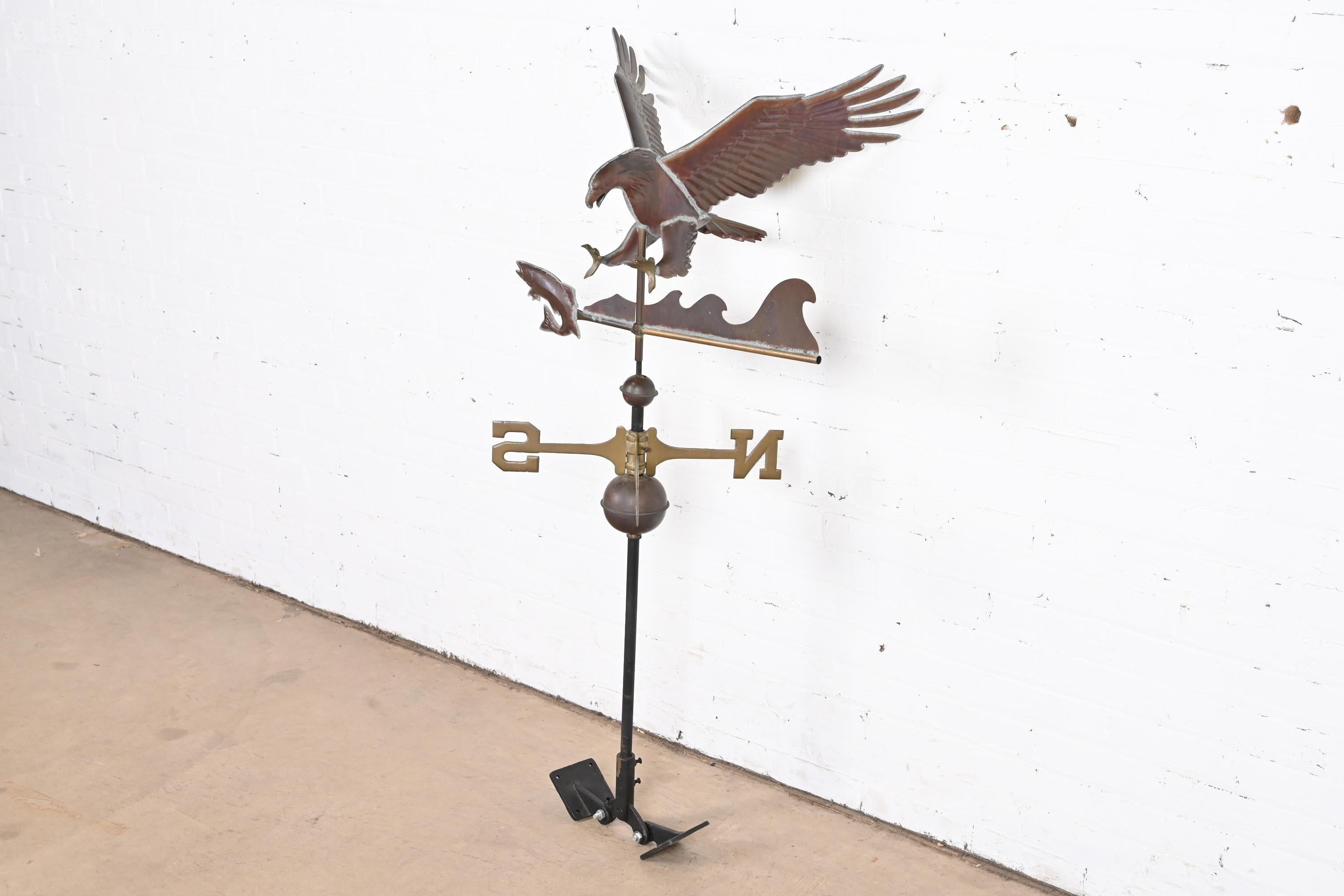 A gorgeous copper weather vane with an eagle hunting a fish

USA, 20th century

Cast copper and brass, on wrought iron stand.

Measures: 24
