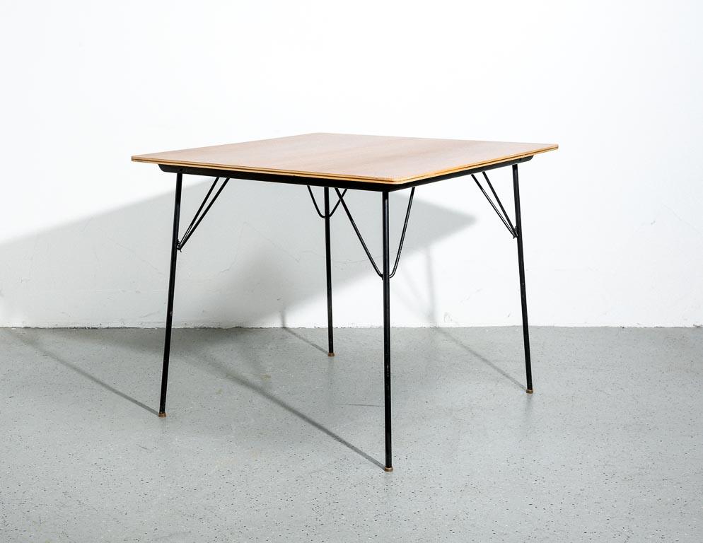 Vintage DTM-1 folding card or dining table designed by Charles and Ray Eames for Herman Miller, c.1950. Walnut top with black painted legs.